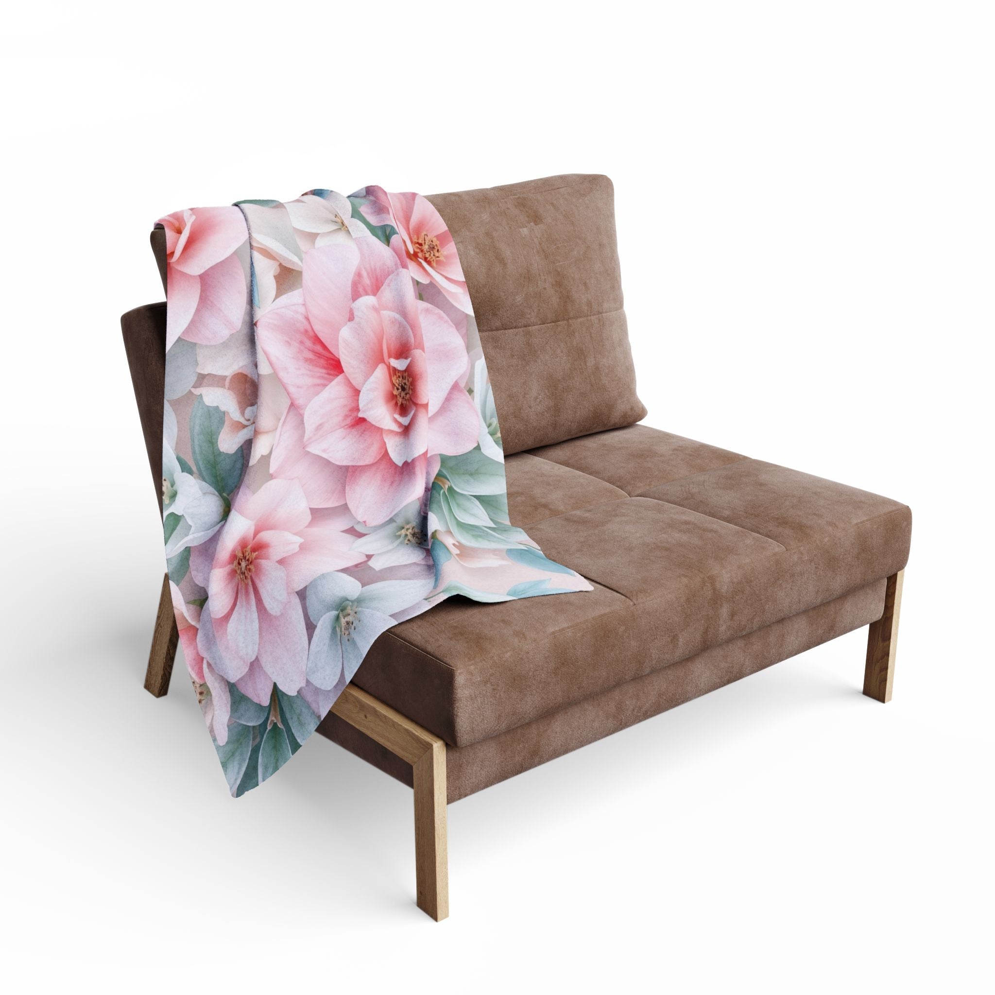 Floral blanket draped over a brown sofa on a white background.