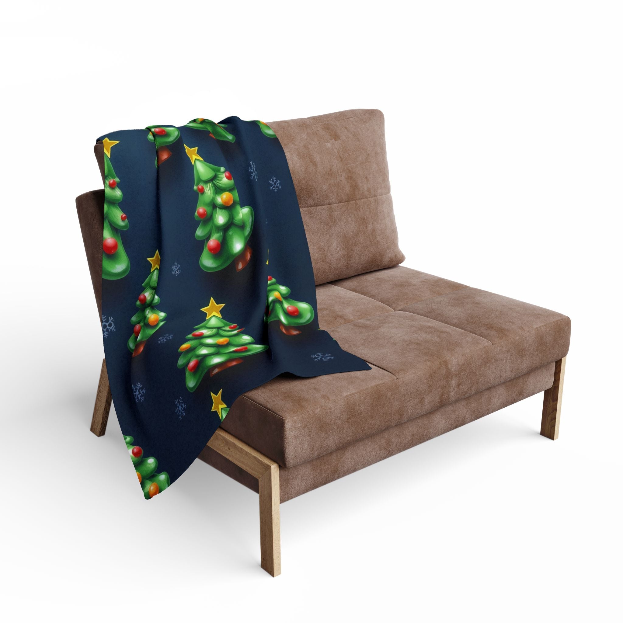 Navy blanket with Christmas tree pattern draped over a brown sofa.