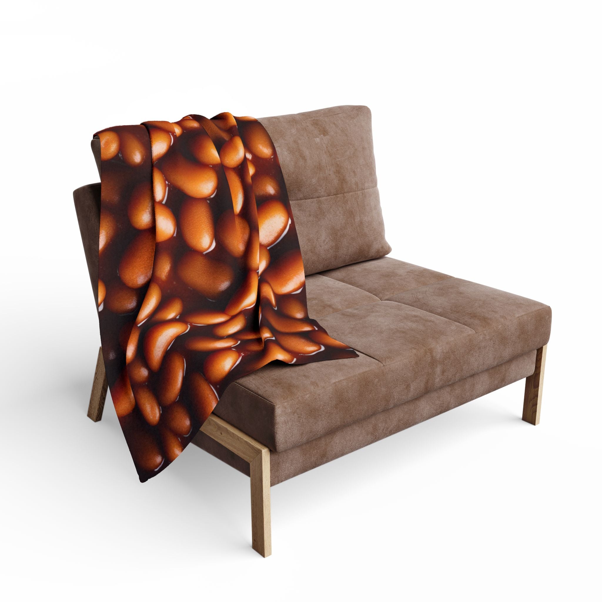 Brown sofa with a baked bean patterned throw blanket on a white background.