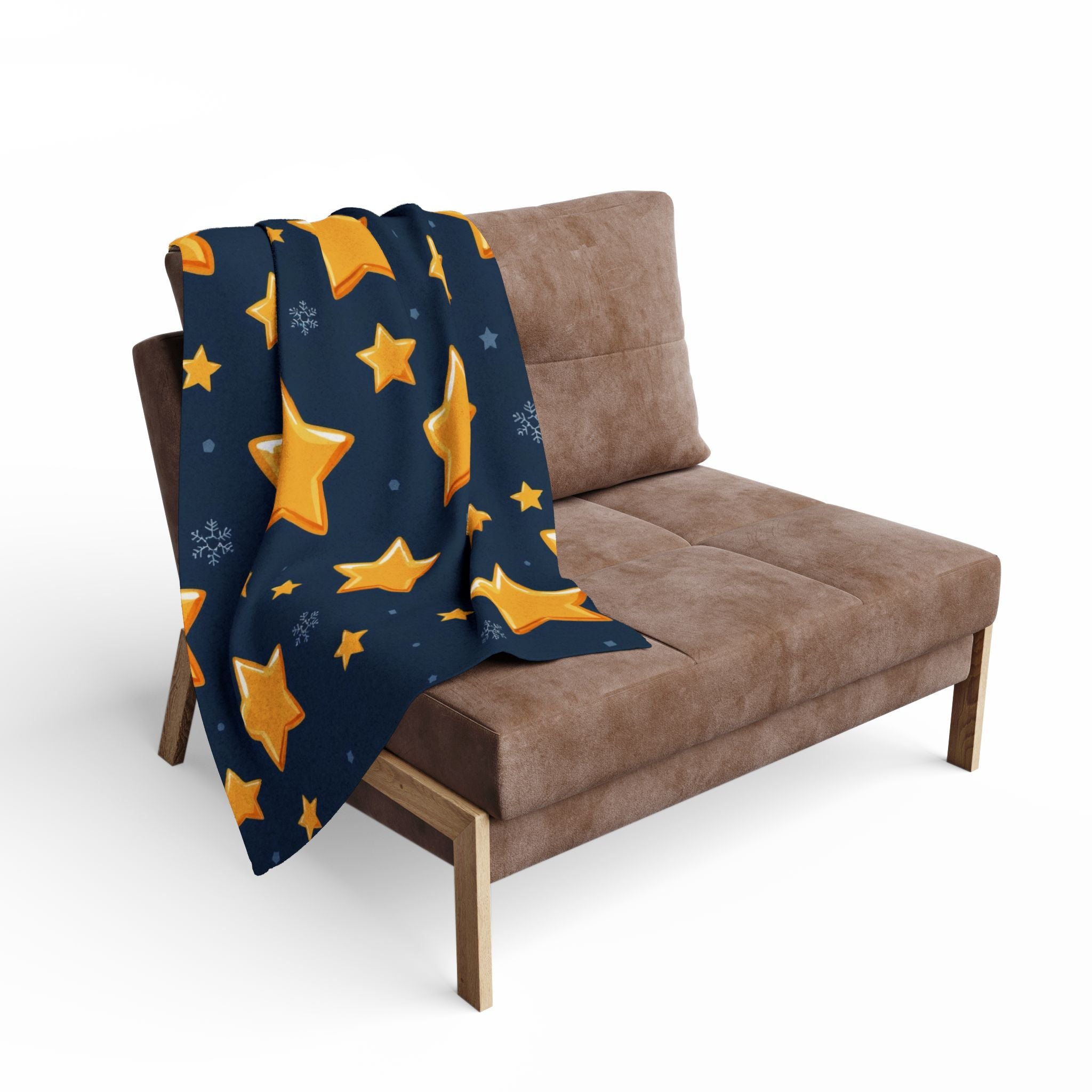 Navy blanket with yellow stars draped over a brown sofa on a white background.