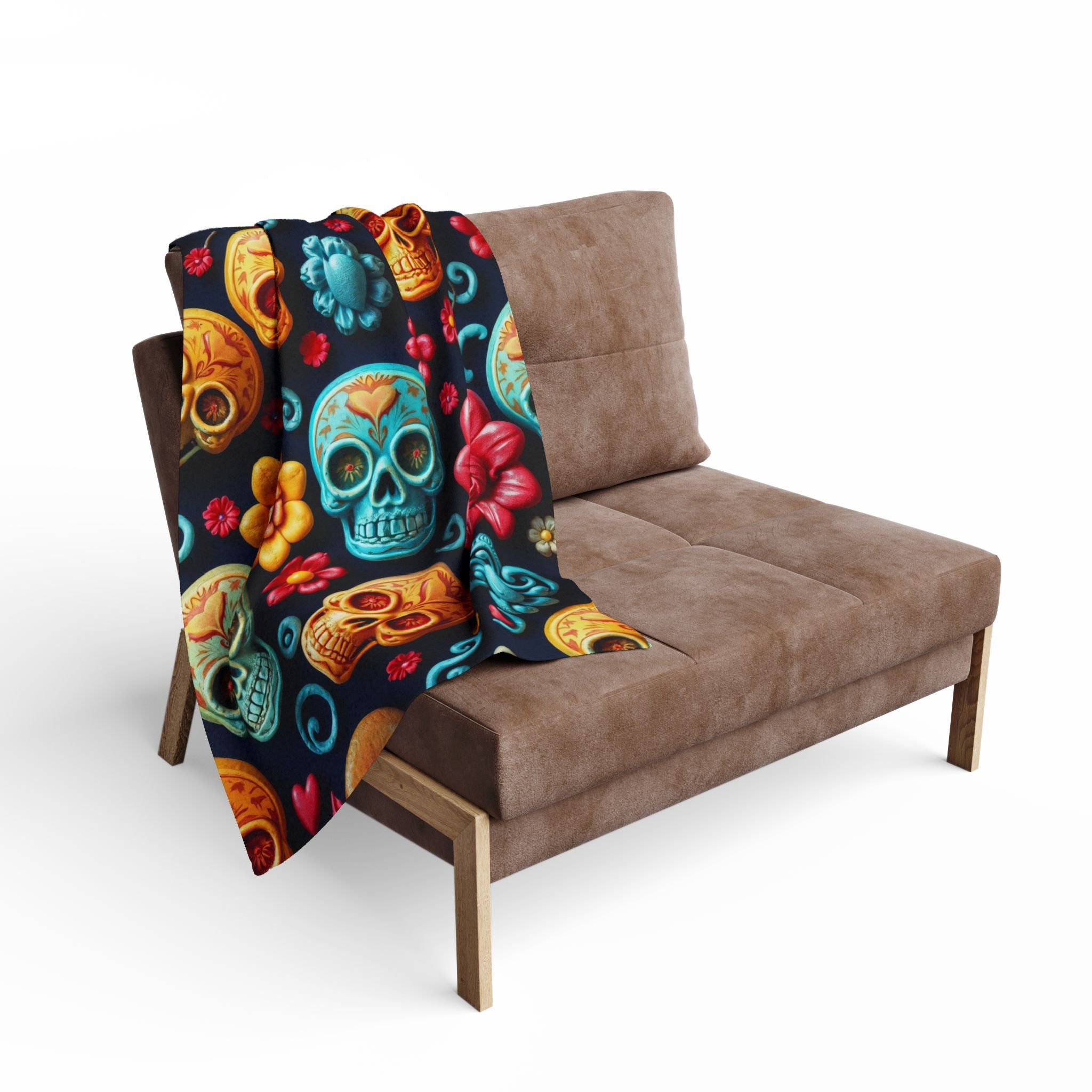 Colorful mexican sugar skull patterned blanket draped over a brown sofa on a white background.