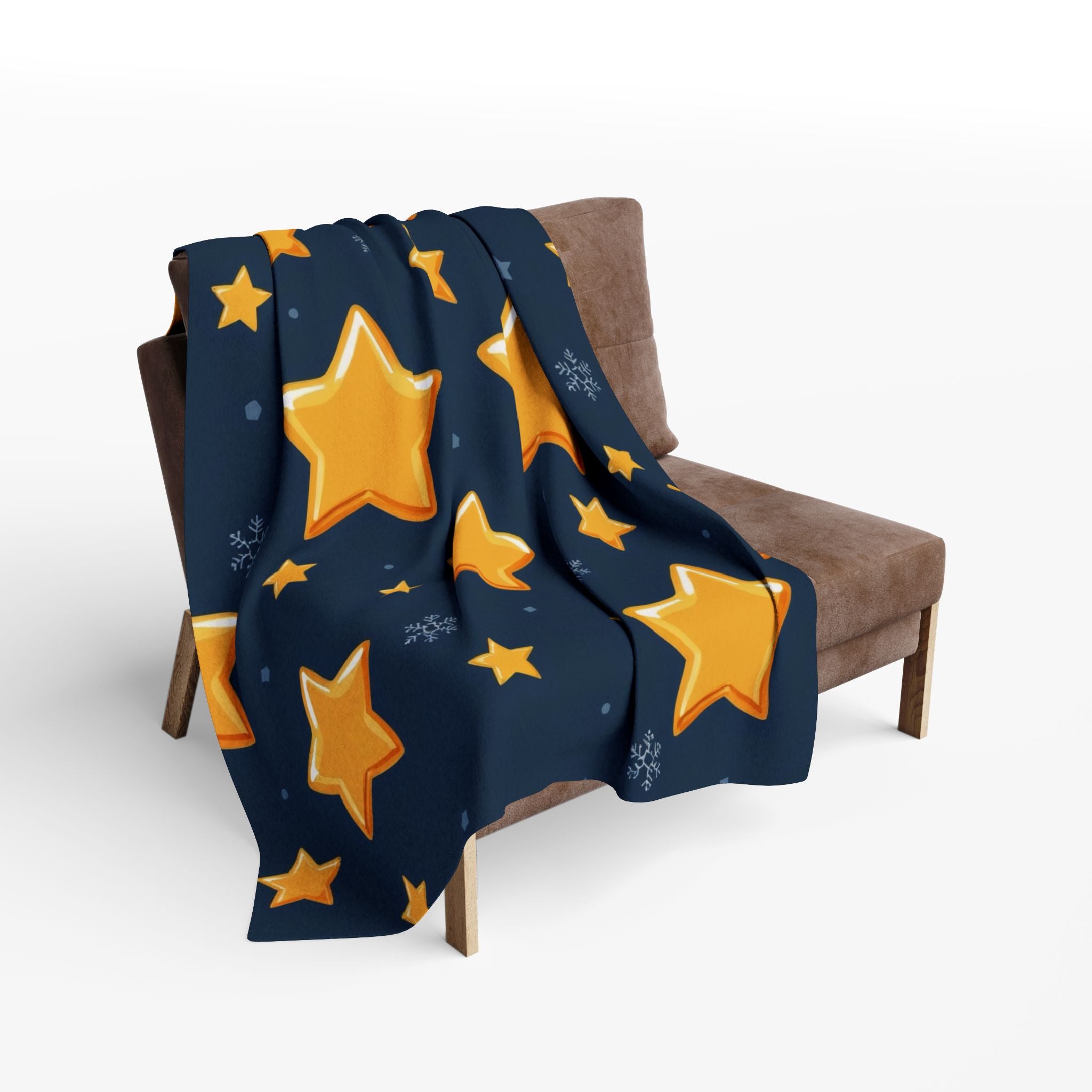 Navy blue blanket with yellow stars draped over a brown chair on a white background.
