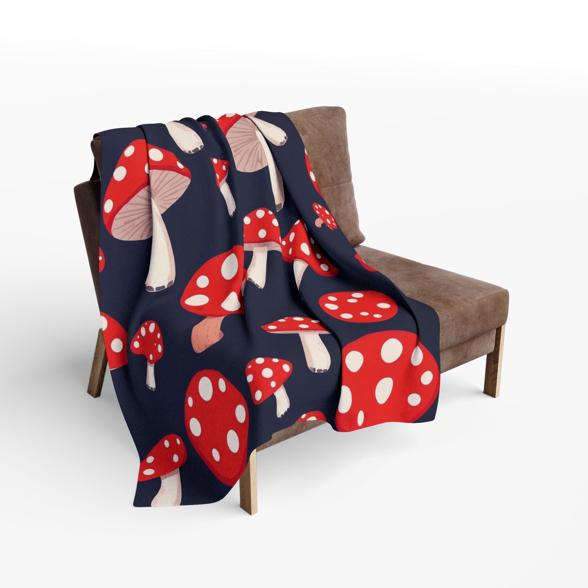 Fleece blanket with red and white mushroom pattern draped over a chair.