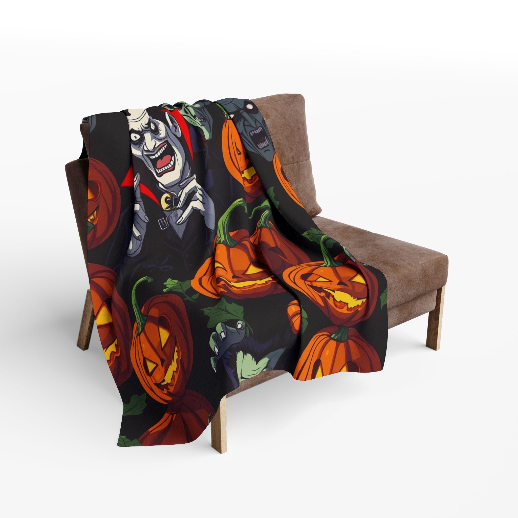 Halloween themed fleece blanket with spooky pumpkin lanterns, Dracula and Frankenstein draped over a chair on a white background.