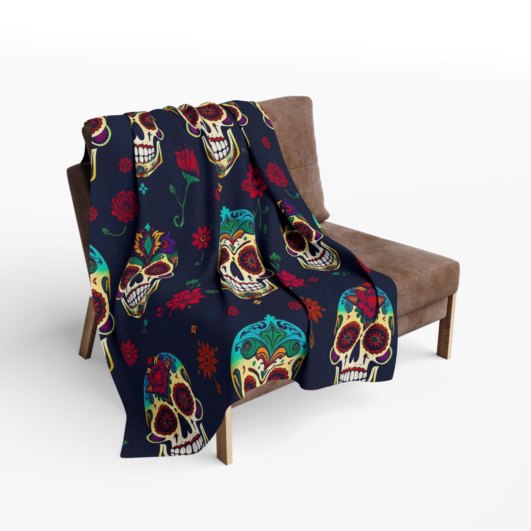 Colorful mexican day of the dead sugar skull patterned fleece blanket throw draped over a brown chair on a white background.
