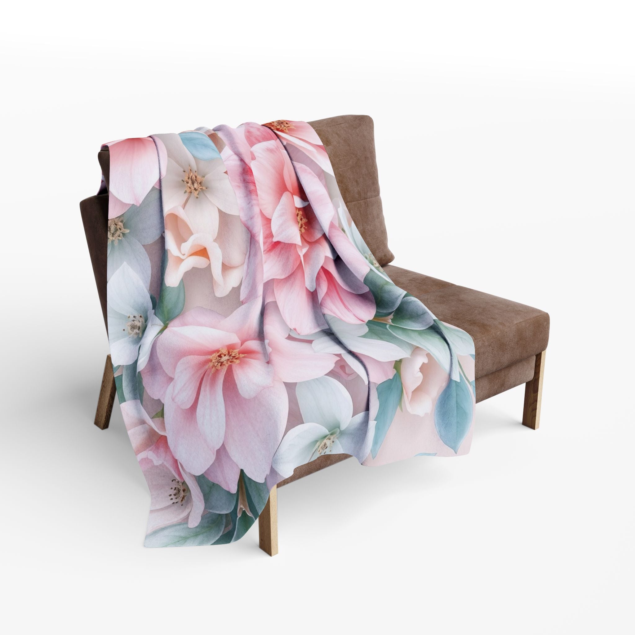 Floral-patterned blanket draped over a chair on a white background.