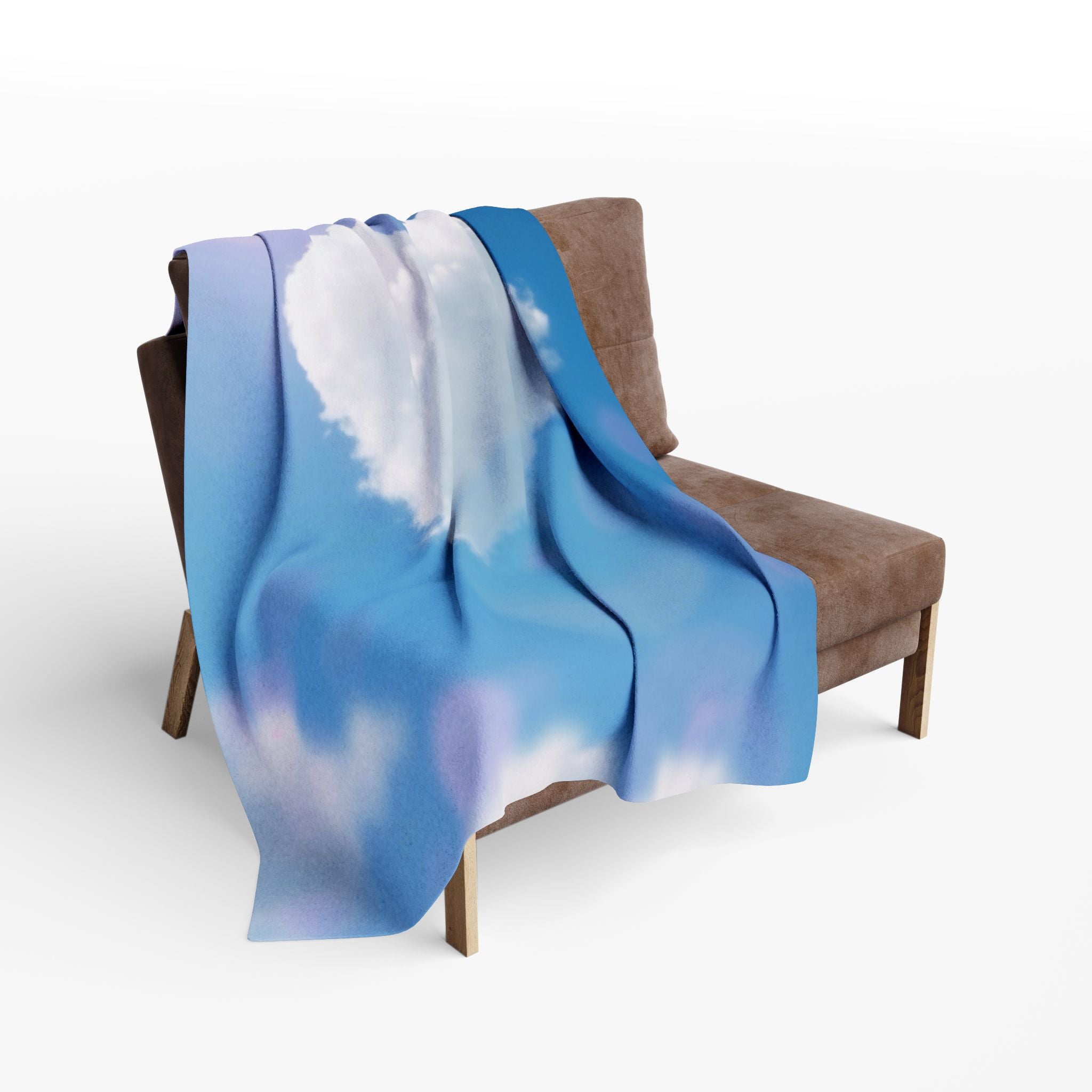 Heart shaped cloud on a blue sky fleece blanket draped over a brown chair on a white background.
