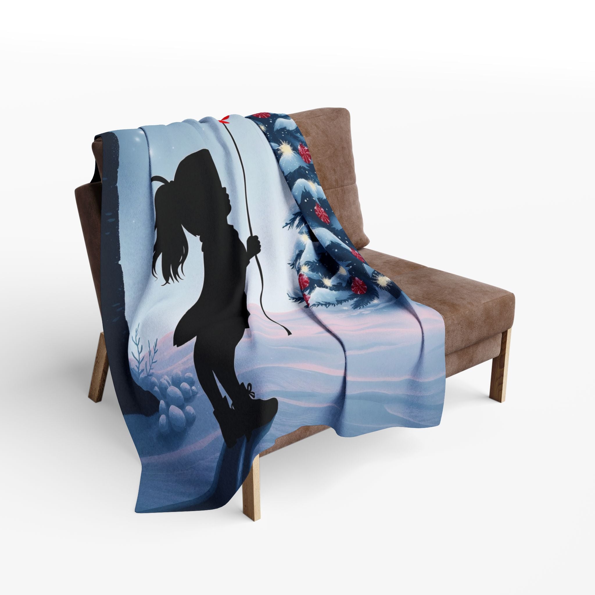 Blanket with a silhouette of a small girl holding a red balloon in a winter a banksy inspired design draped over a chair.