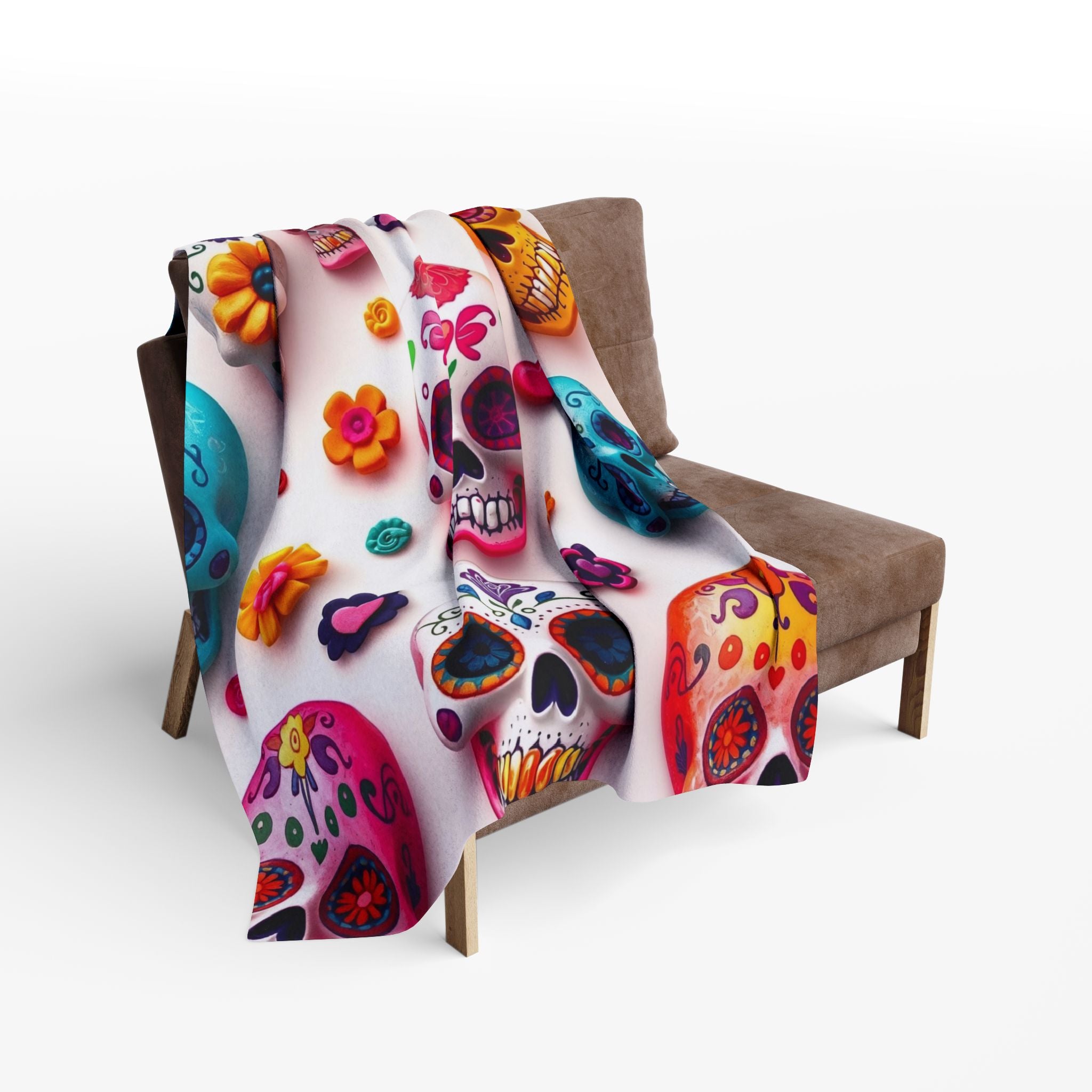 Colorful sugar skull and floral patterned fleece blanket throw draped over a chair on a white background.