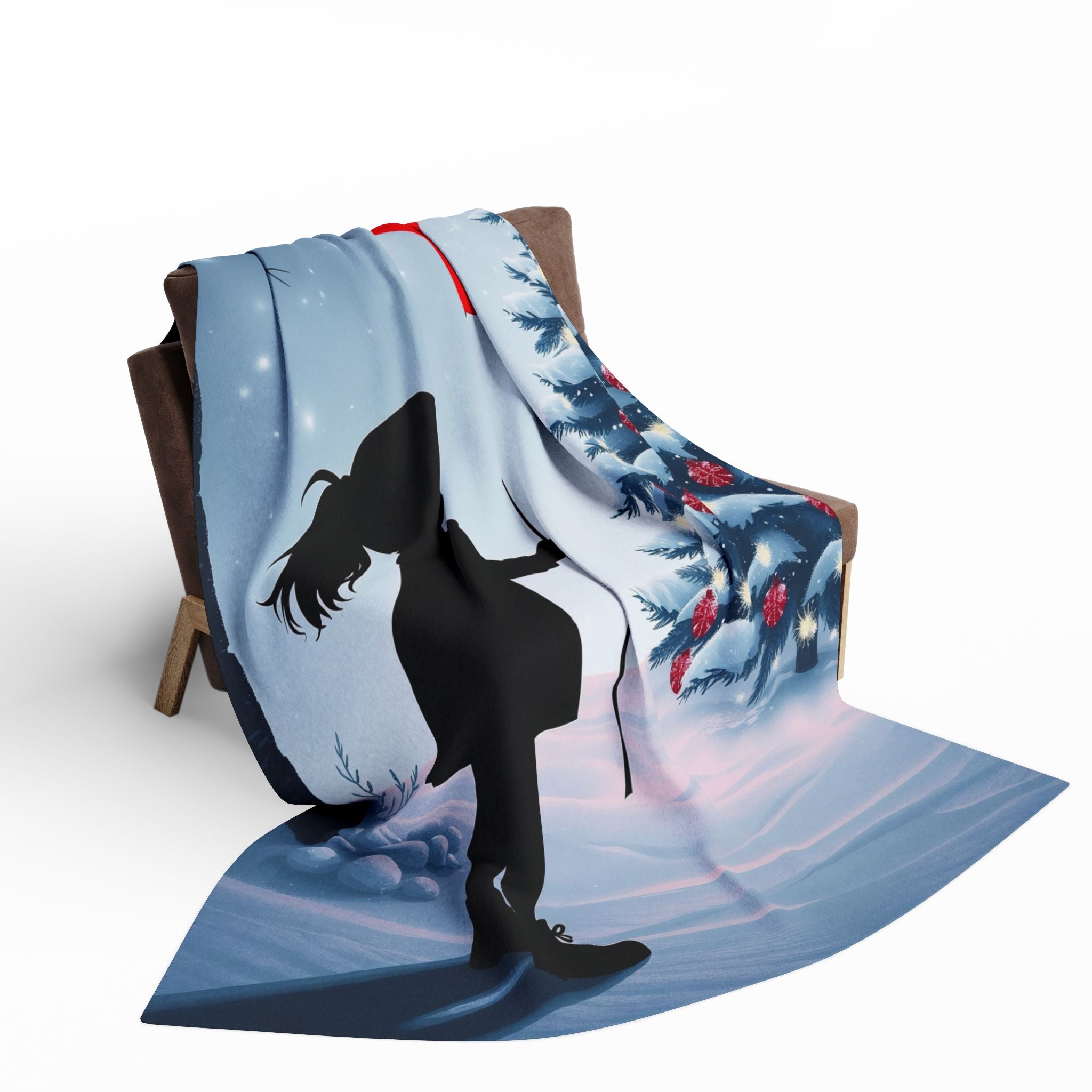 Blanket with a silhouette of a girl holding a red balloon with a christmas tree design draped over a chair on a white background.