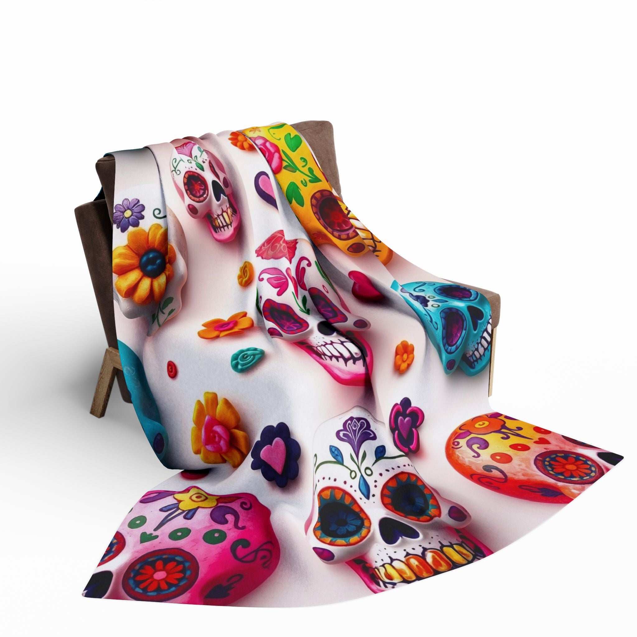 Colorful Mexican day of the dead sugar skull-themed fleece blanket draped over a chair on a white background.
