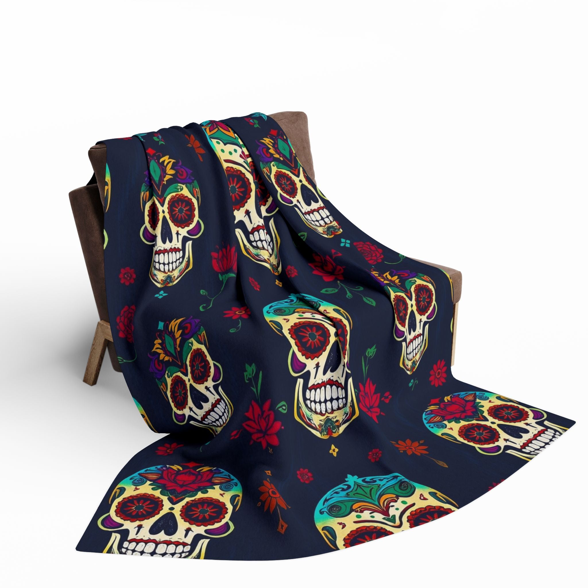Colorful mexican day of the dead sugar skull patterned blanket throw draped over a chair on a white background.