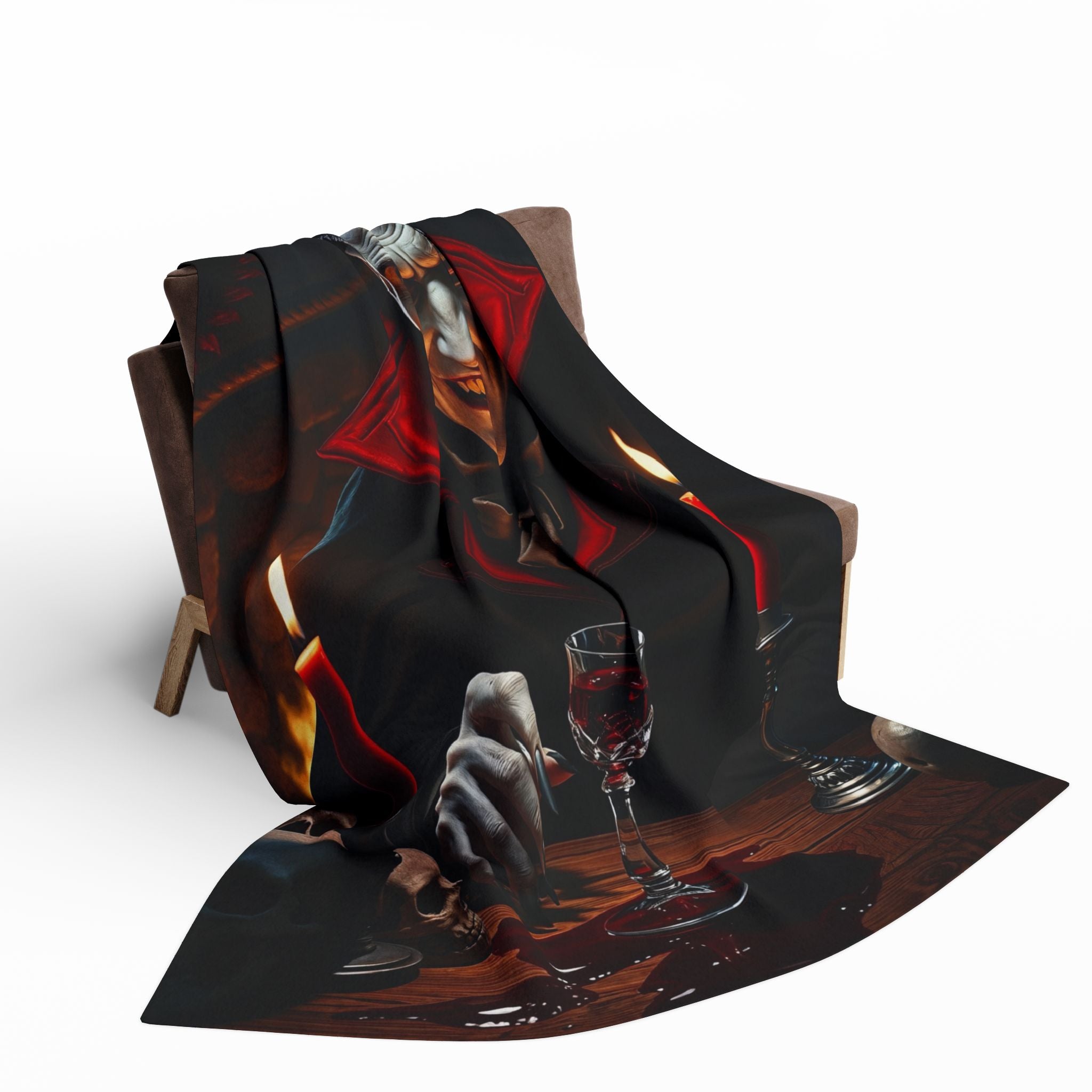 Fleece blanket with a halloween themed dracula design draped over a chair on a white background.
