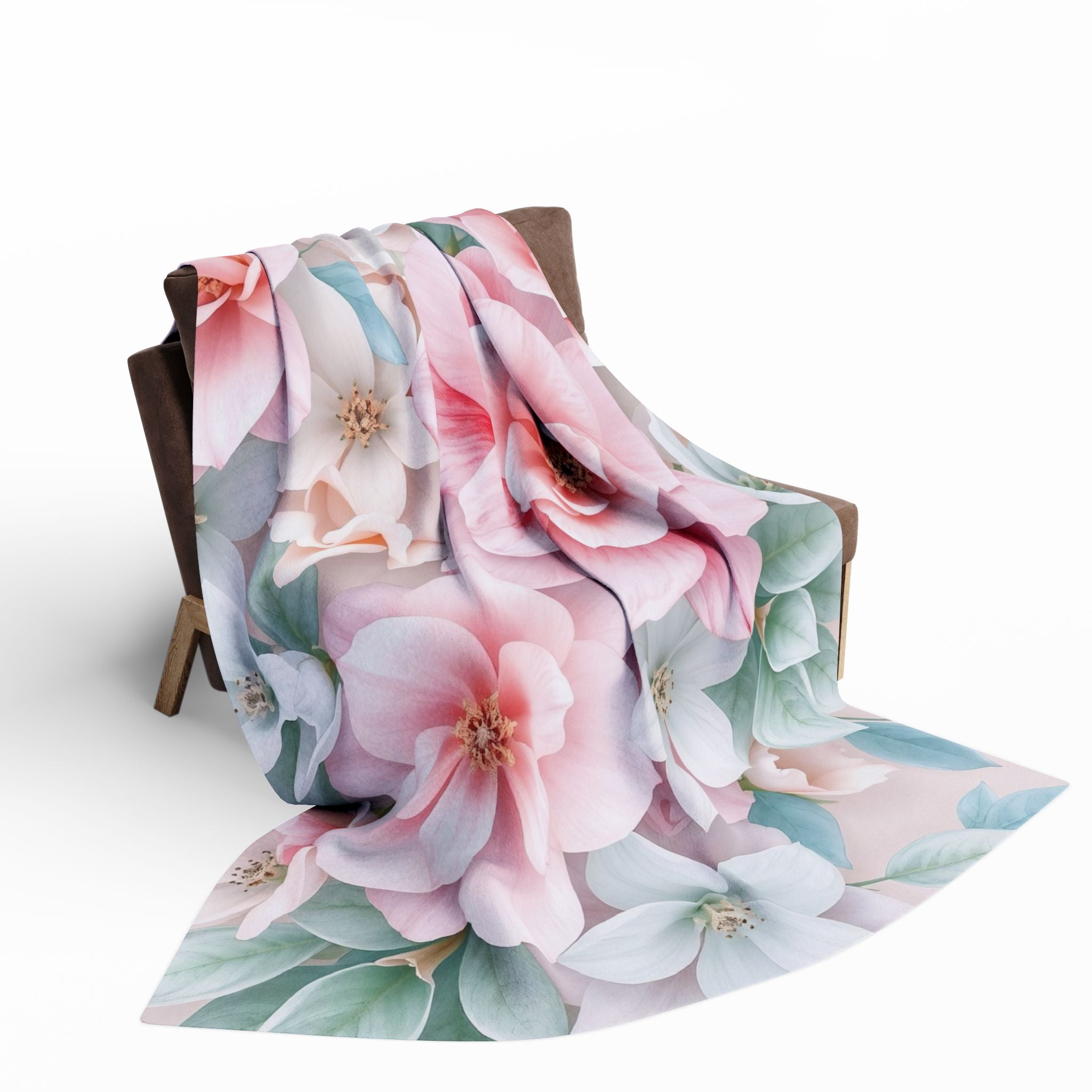 Floral patterned blanket draped over a chair on a white background.