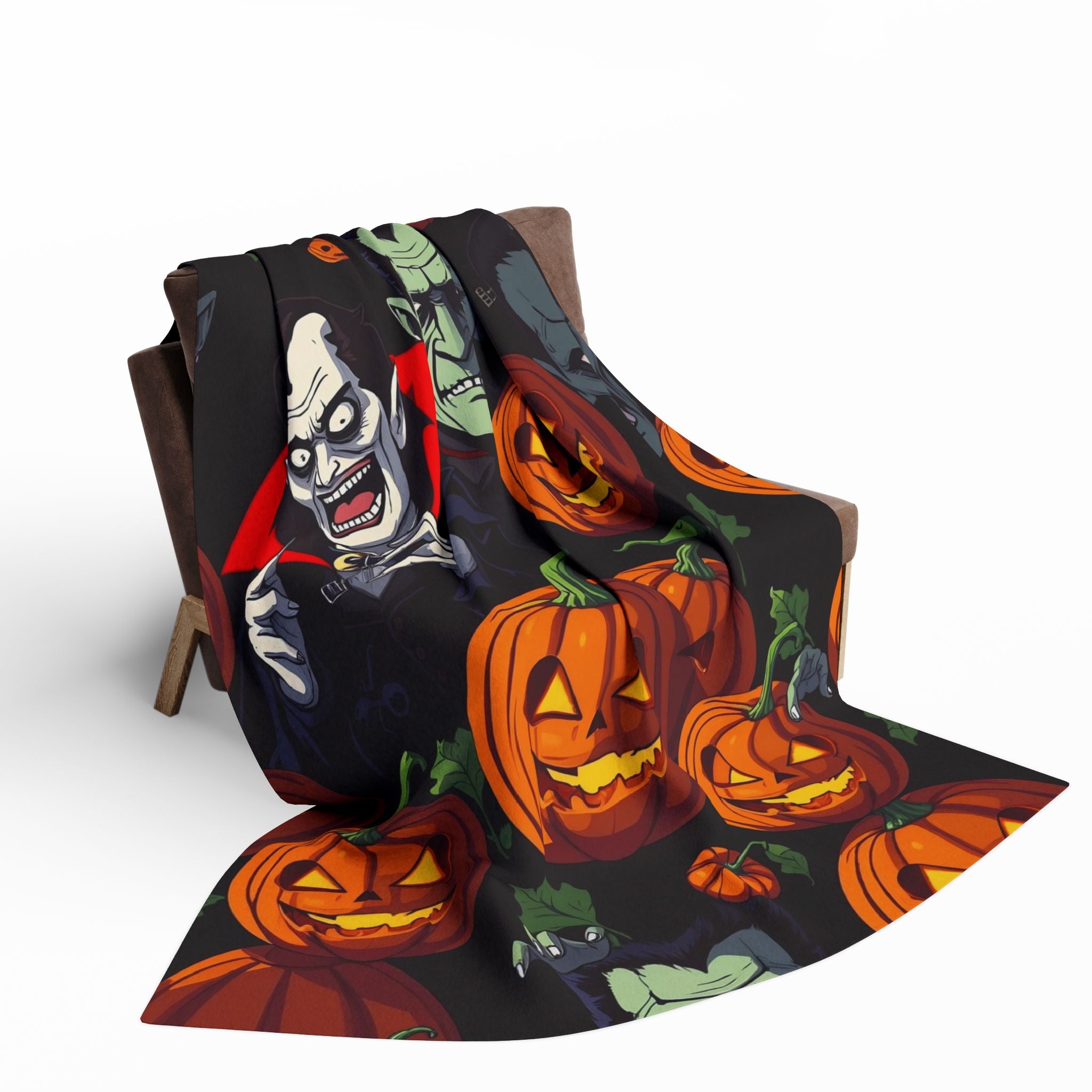 Halloween themed blanket with pumpkin lanterns, vampire, Dracula and Frankenstein on a chair.