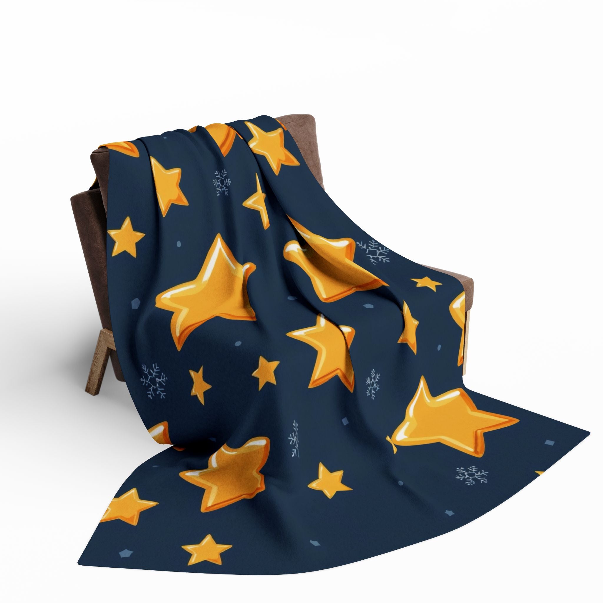 Navy blue blanket with yellow star patterns draped over a wooden chair on a white background.