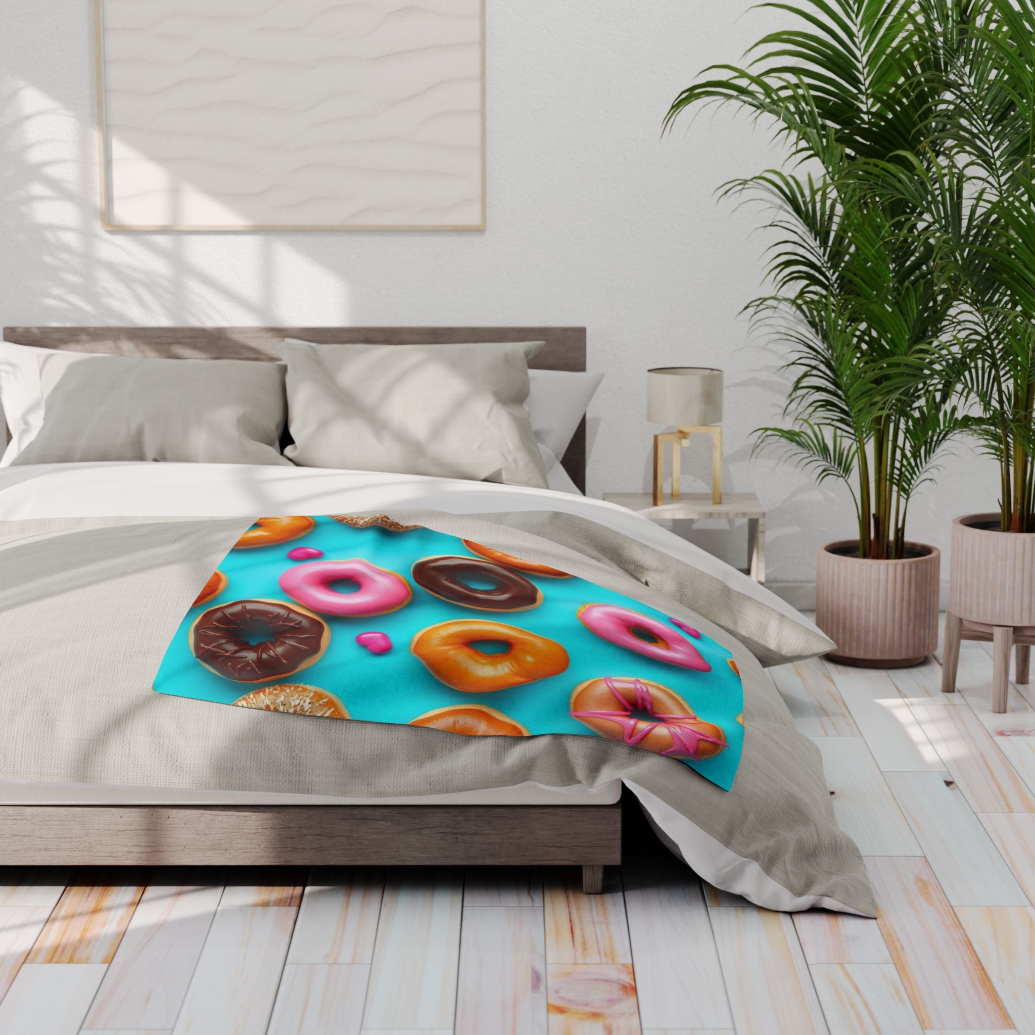 Bed with colourful doughnut patterned fleece blanket in a bright bedroom.