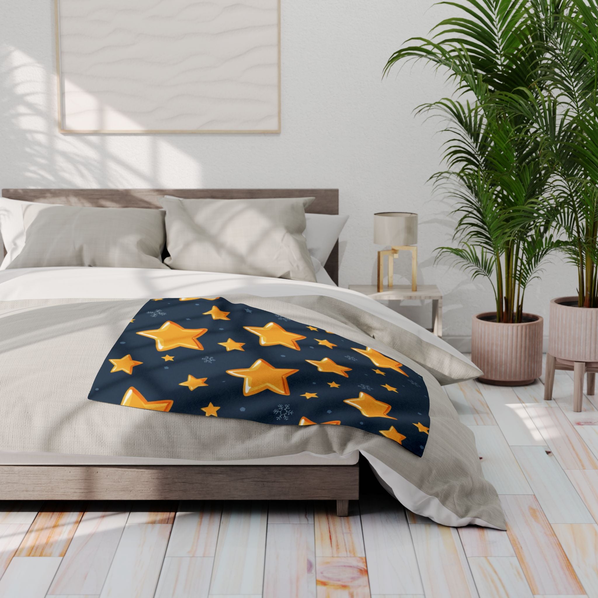 Bed with a star-patterned blue blanket in a bright bedroom setting.