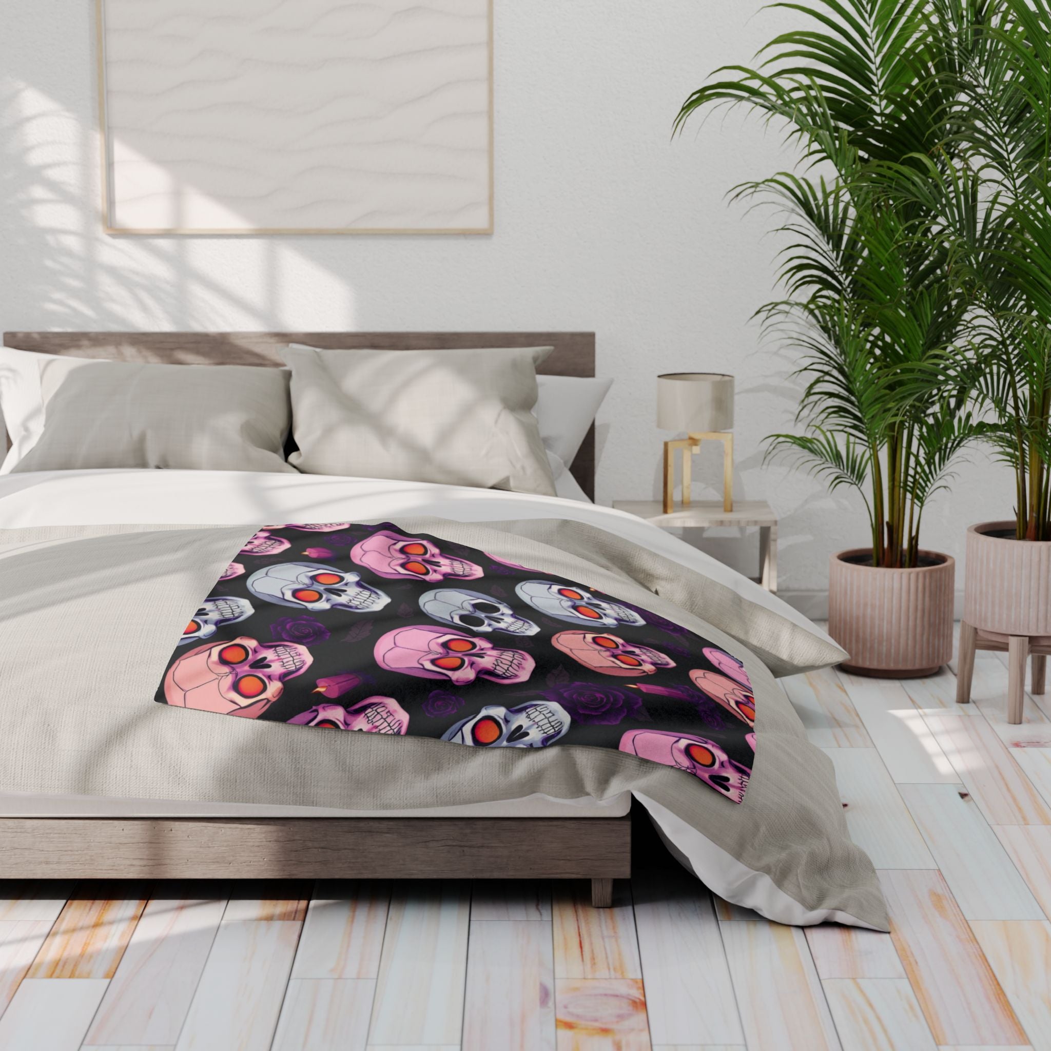 Bedroom with a colorful spooky halloween skull patterned blanket on a bed.