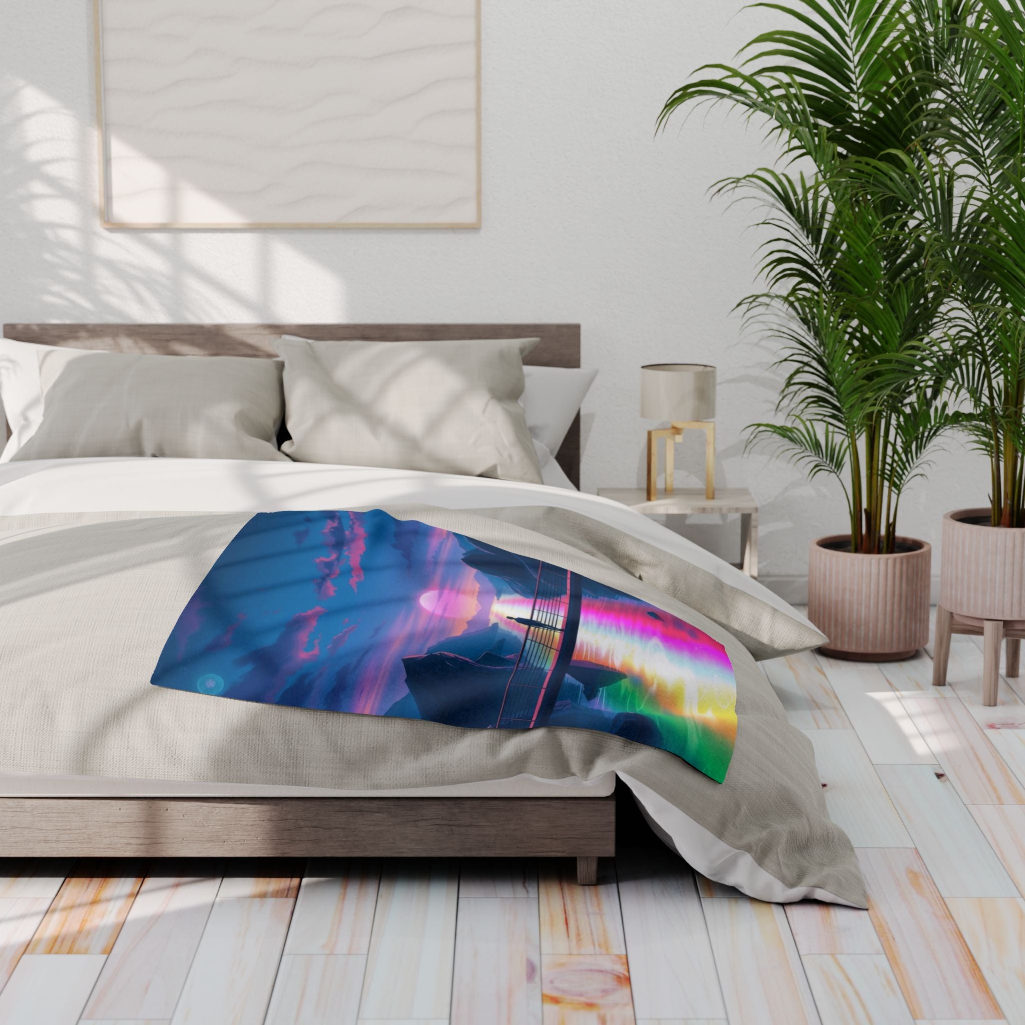 Bedroom with a colorful fleece blanket featuring a sunset design, plants, and a lamp.