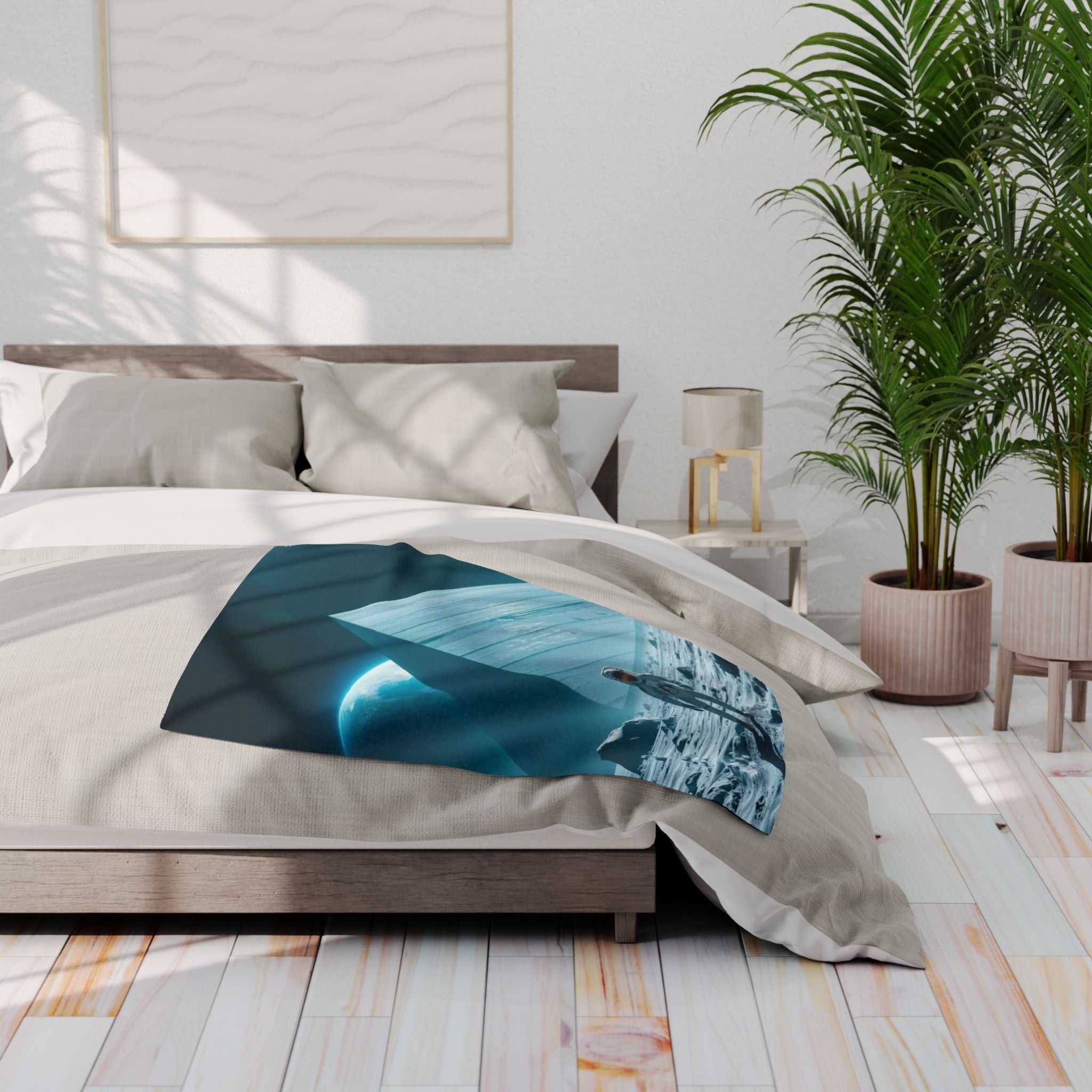 Bedroom with a bed featuring a fleece blanket with a huge ancient pyramid on the moon with an astronaut, a nightstand with a lamp, and a plant.