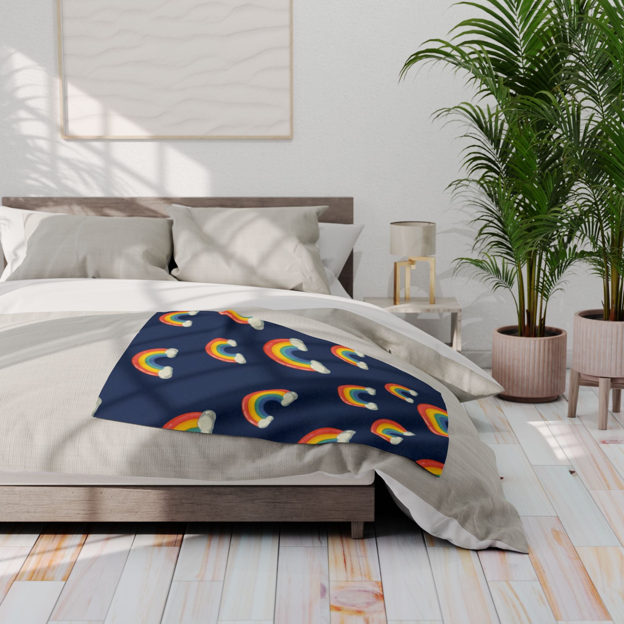 Bed with rainbow-patterned blanket in a bright bedroom