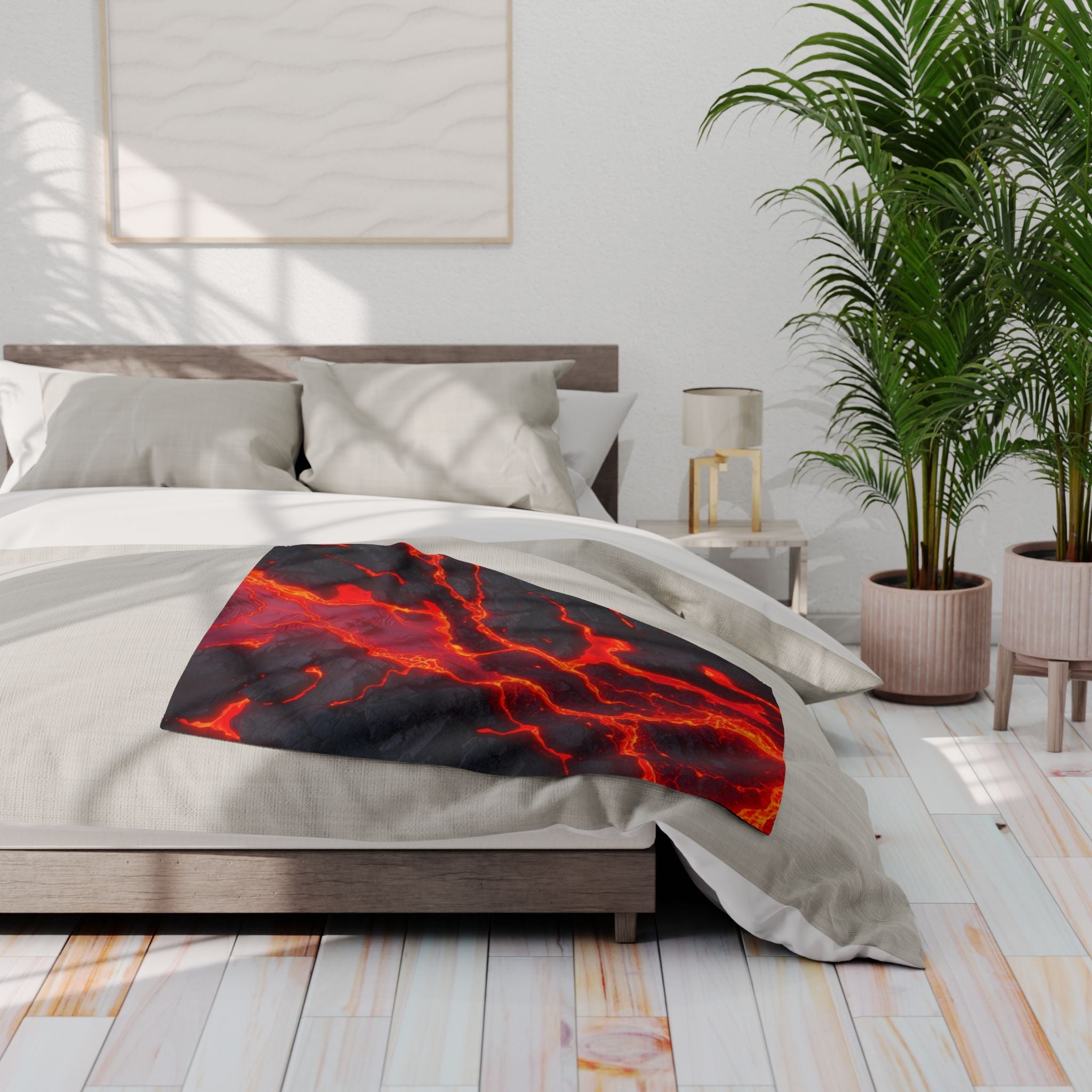 Bedroom with a bed featuring a red and black lava pattern blanket.
