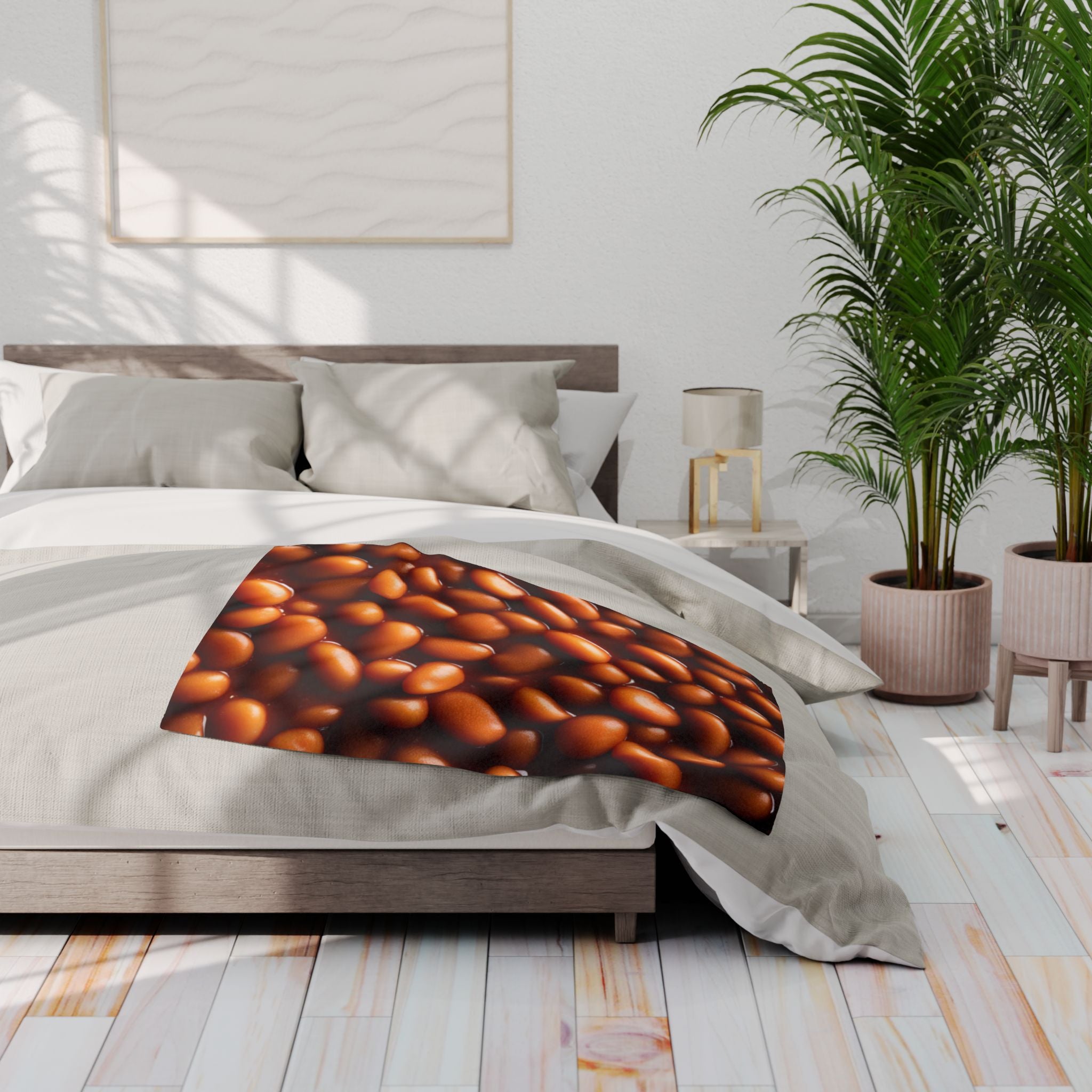 Bed with a baked bean patterned blanket in a bright bedroom setting.