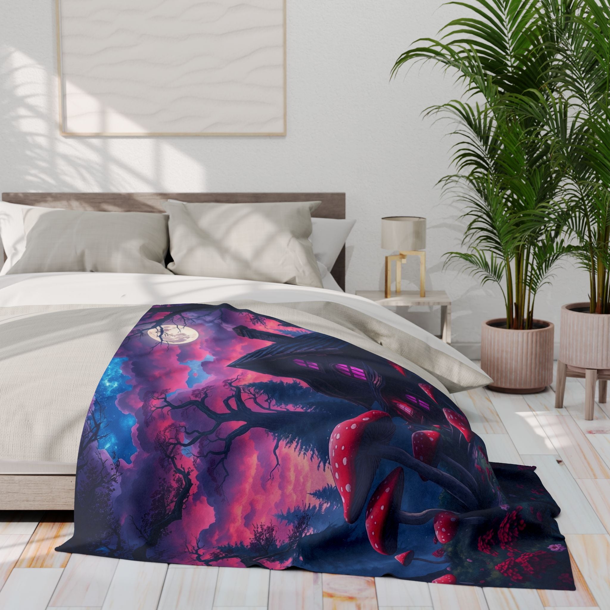 Halloween fleece blanket featuring a haunted house and red and white mushrooms draped over a bed in a bright bedroom with plants and a lamp.