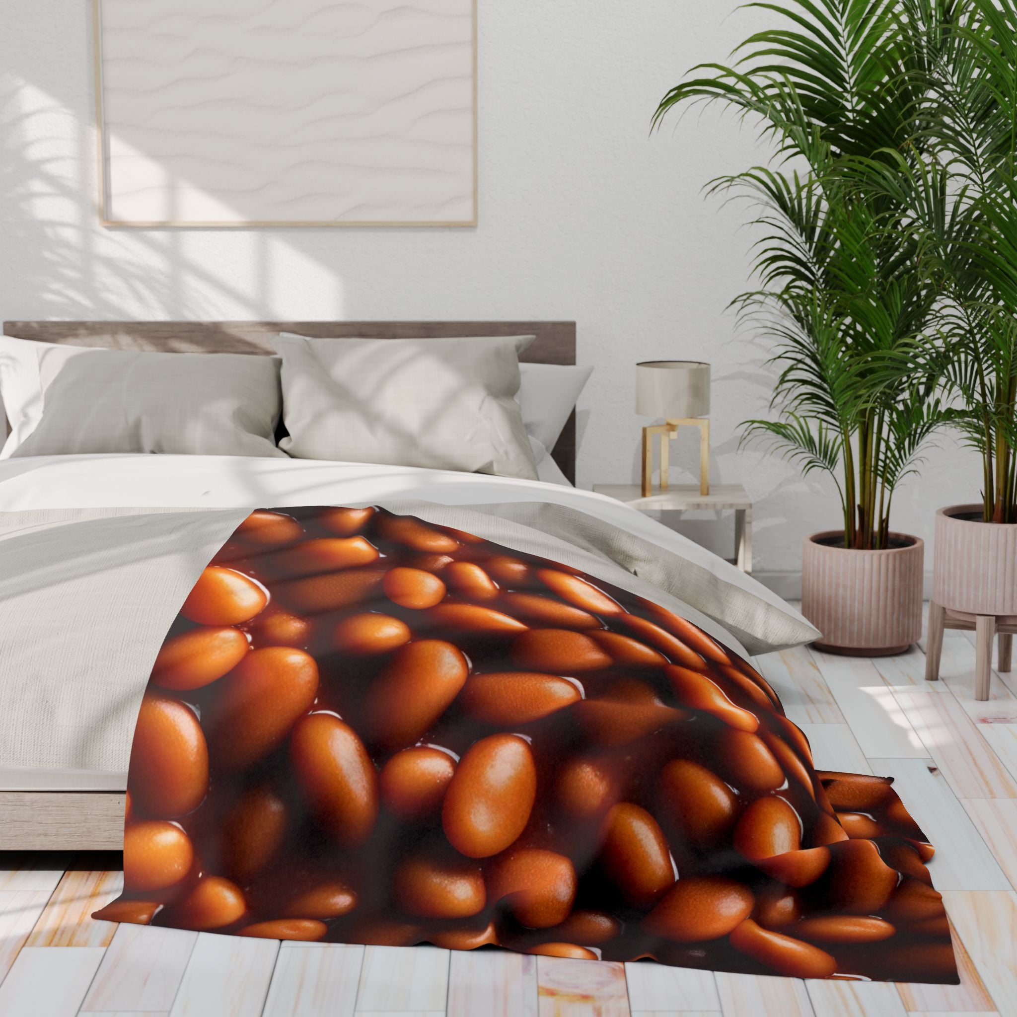 Bed with a baked beans in tomatoe sauce patterned blanket in a bright bedroom.