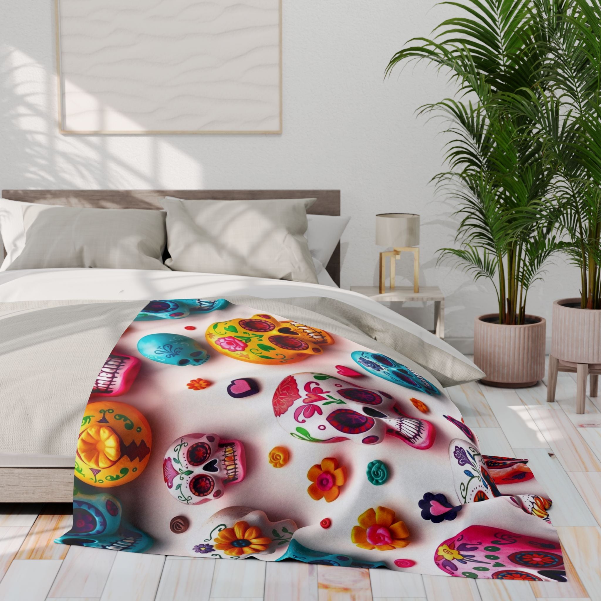 Colorful mexican day of the dead sugar skull and floral patterned fleece blanket throw on a bed in a bright bedroom.