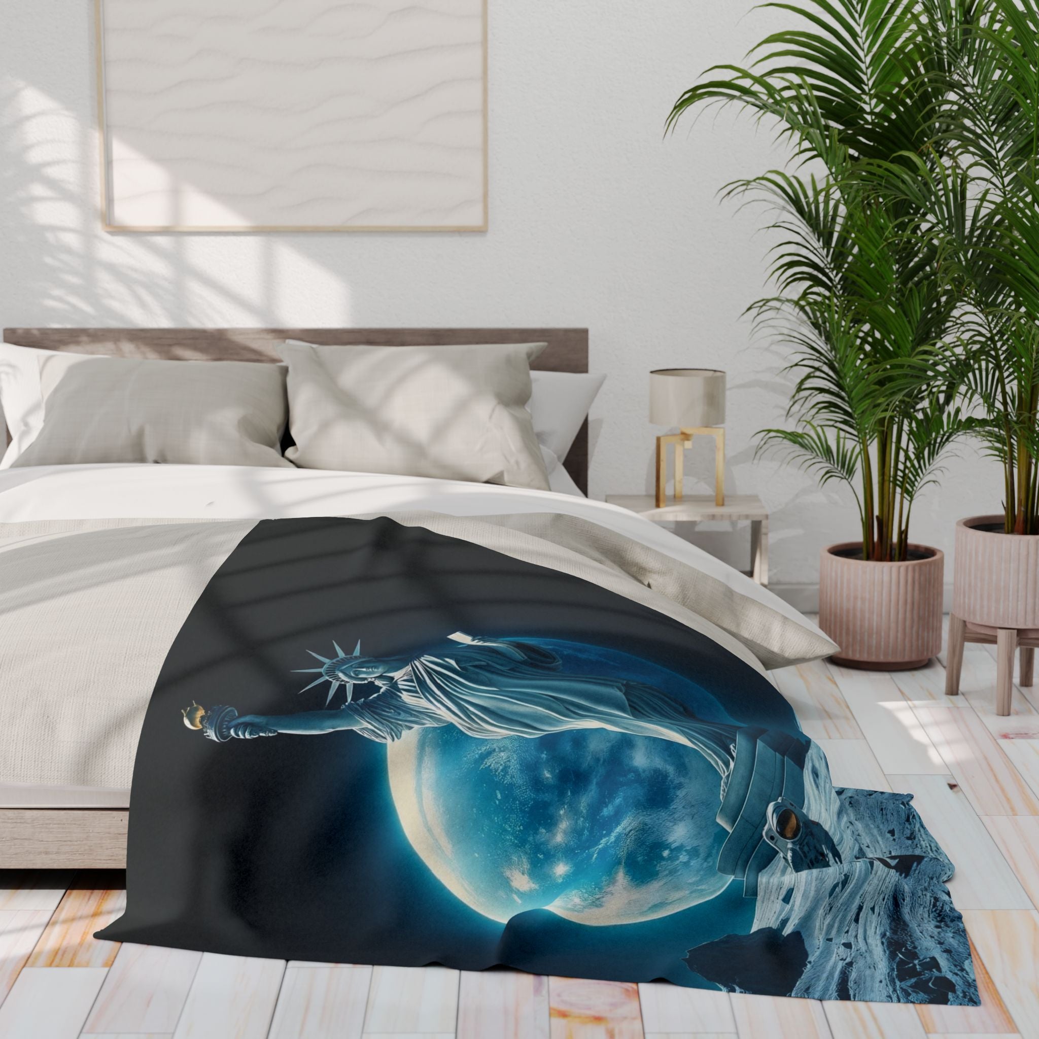 Bed with a decorative fleece blanket featuring  the statue of liberty and an astronaut on the moon , surrounded by a bedroom setting with a plant and lamp.