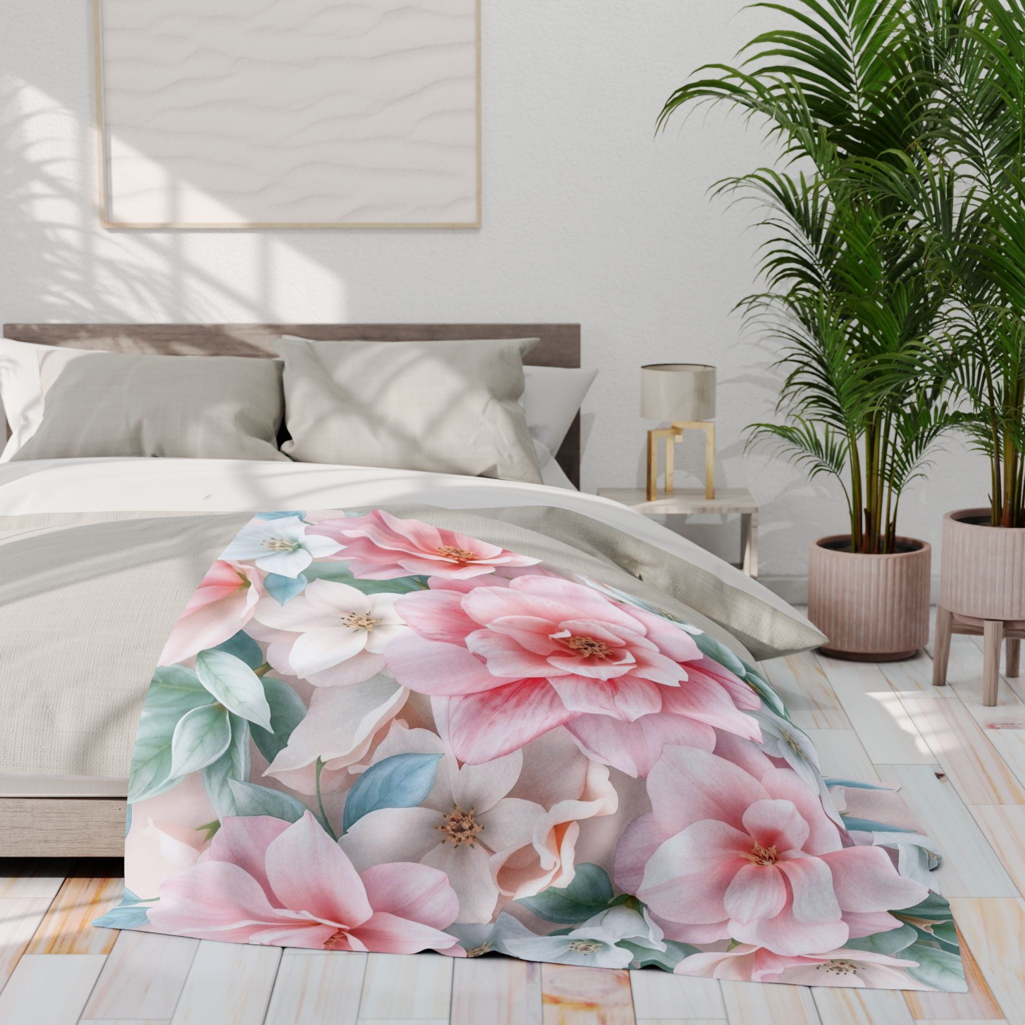 Floral fleece blanket on a bed in a bright bedroom with plants and a lamp.