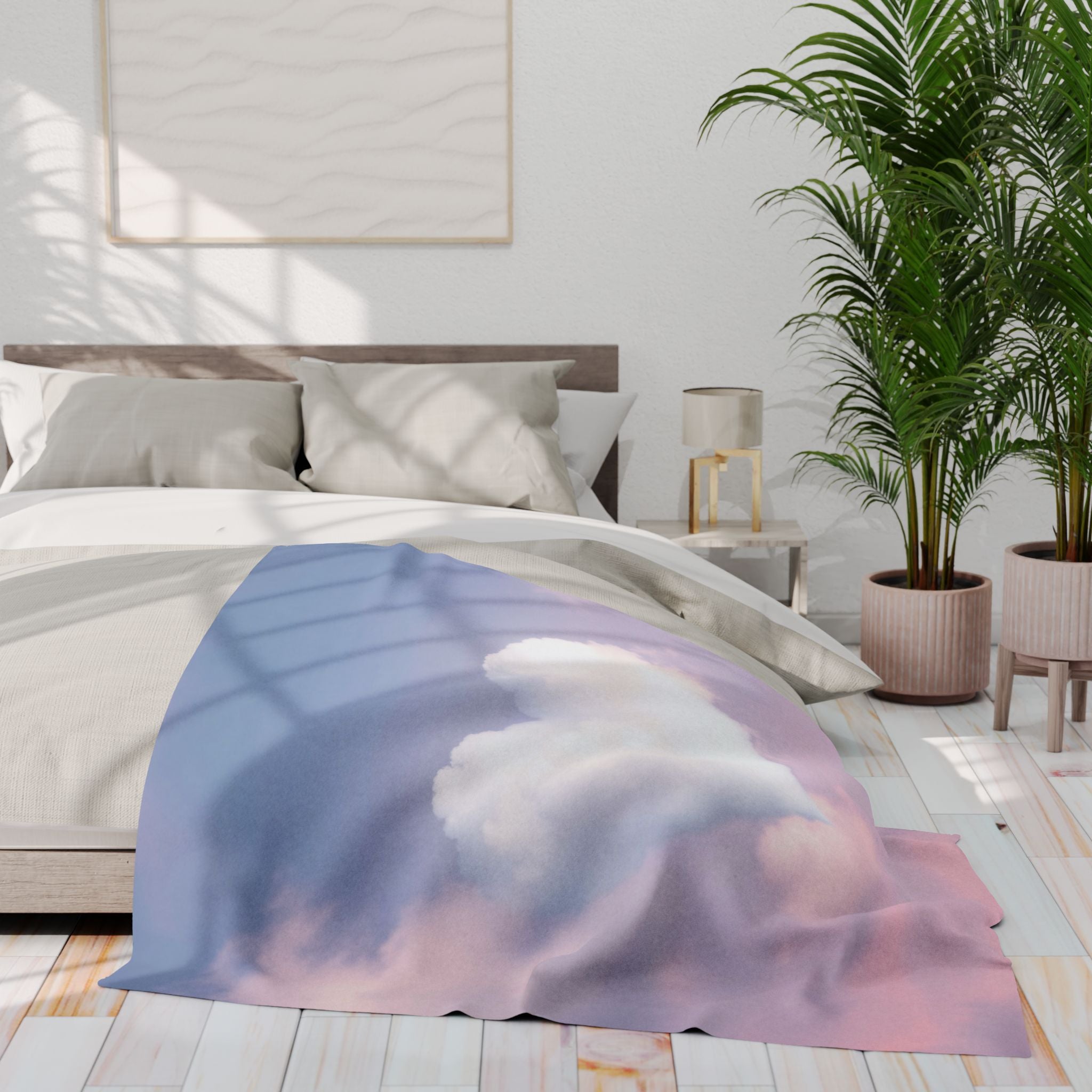 Bed with a heart shaped cloud fleece blanket draped over it in a bedroom setting.
