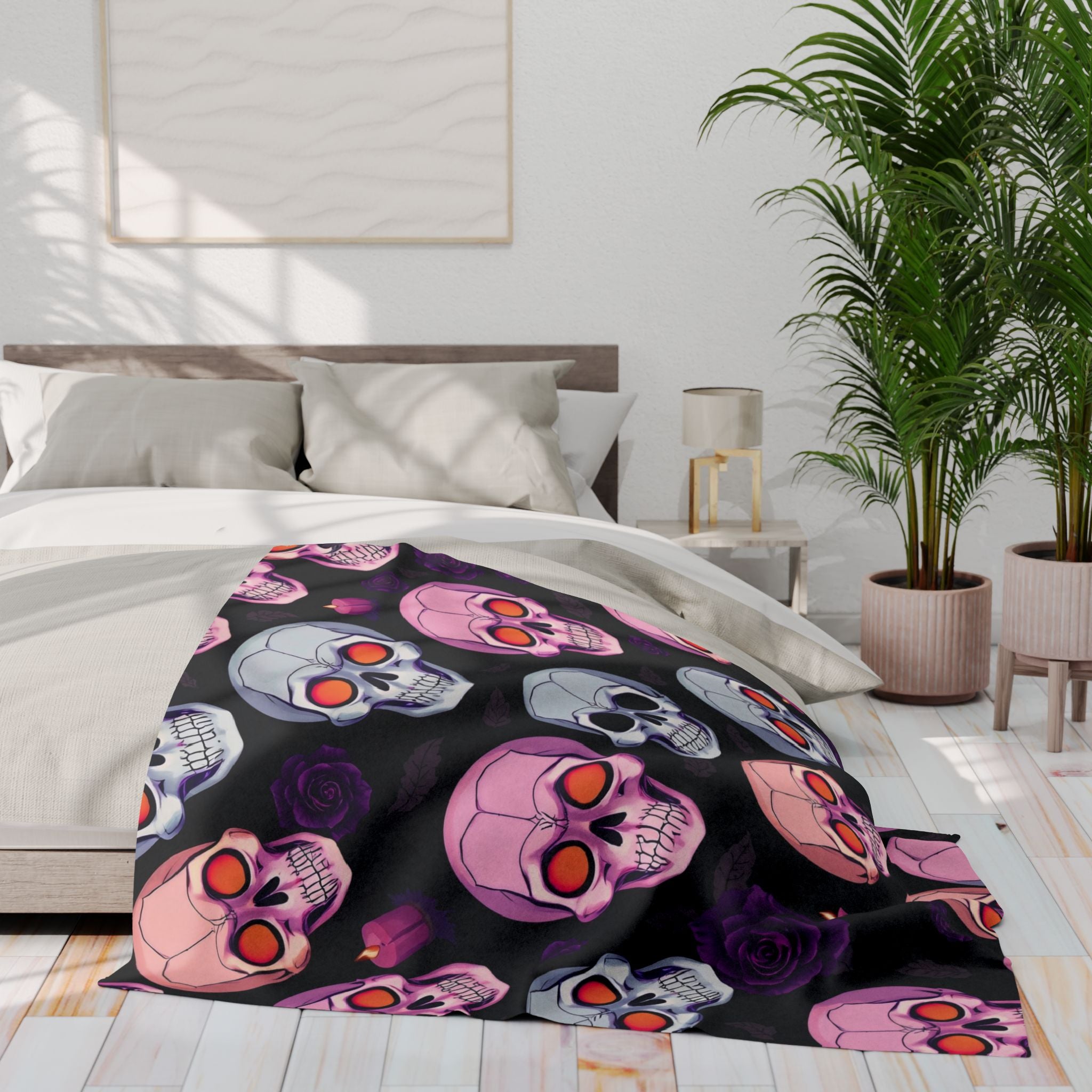 Halloween skull and rose patterned fleece blanket on a bed in a bedroom setting.