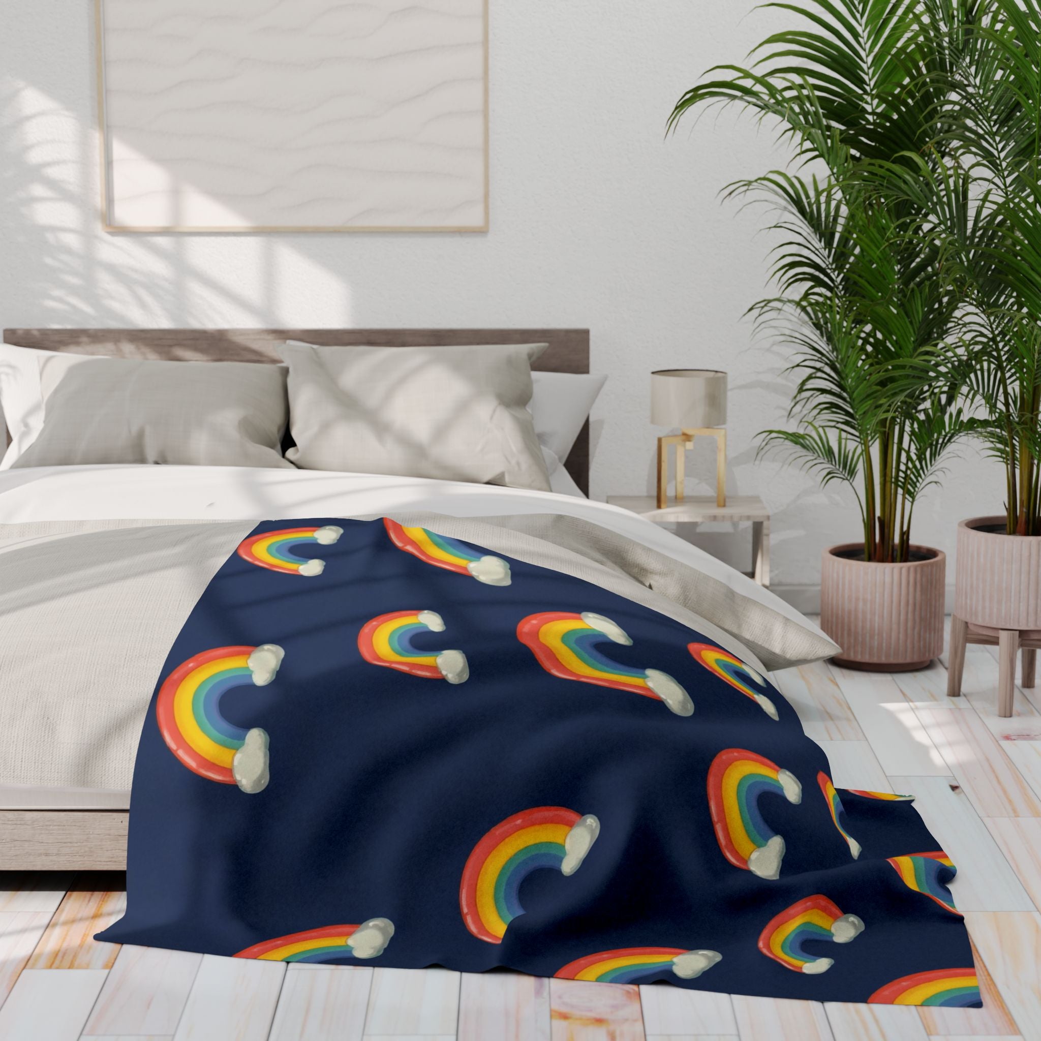 Navy blue blanket with rainbow patterns draped over a bed in a bright bedroom.