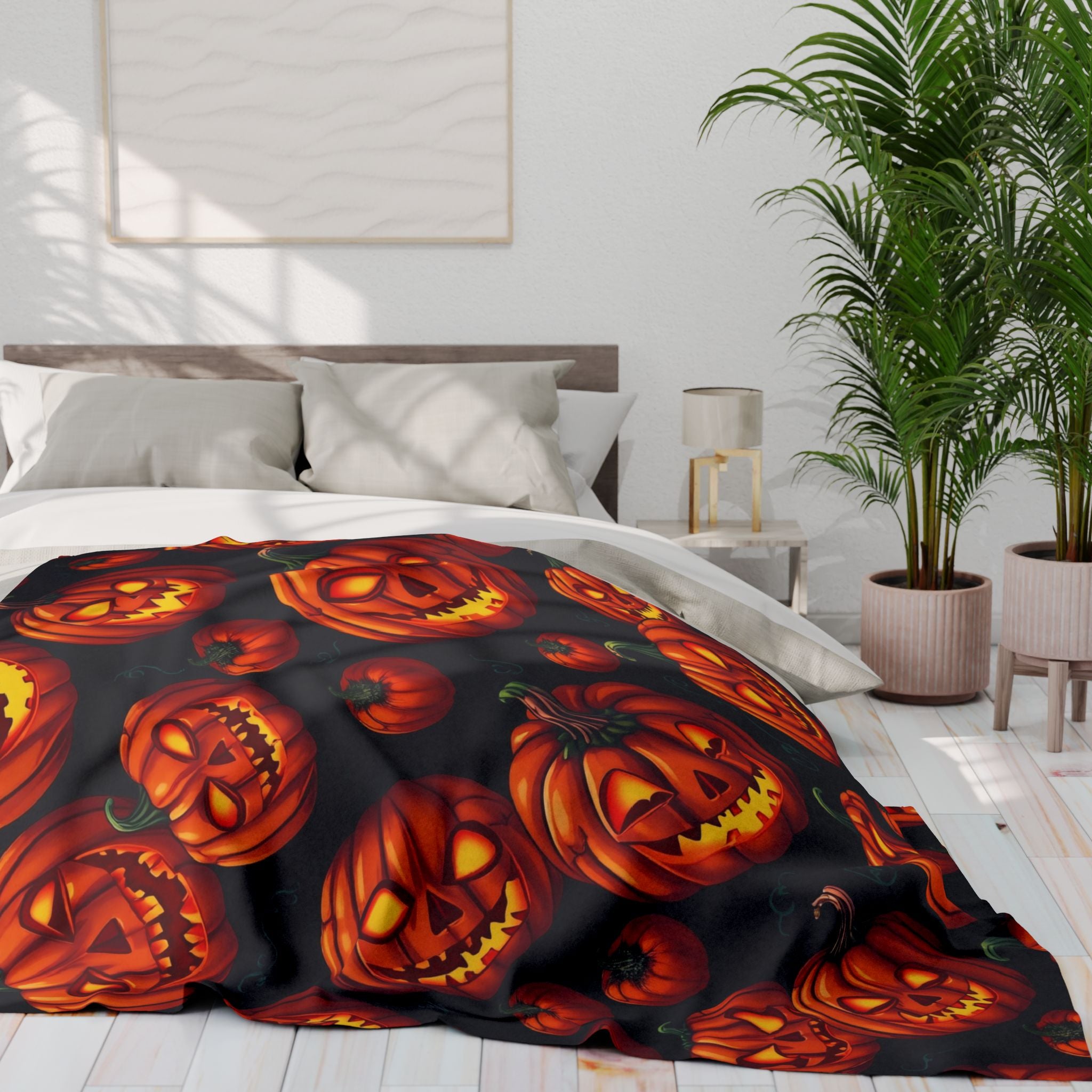 Bed with Halloween-themed scary pumpkin patterned fleece blanket in a bedroom setting.