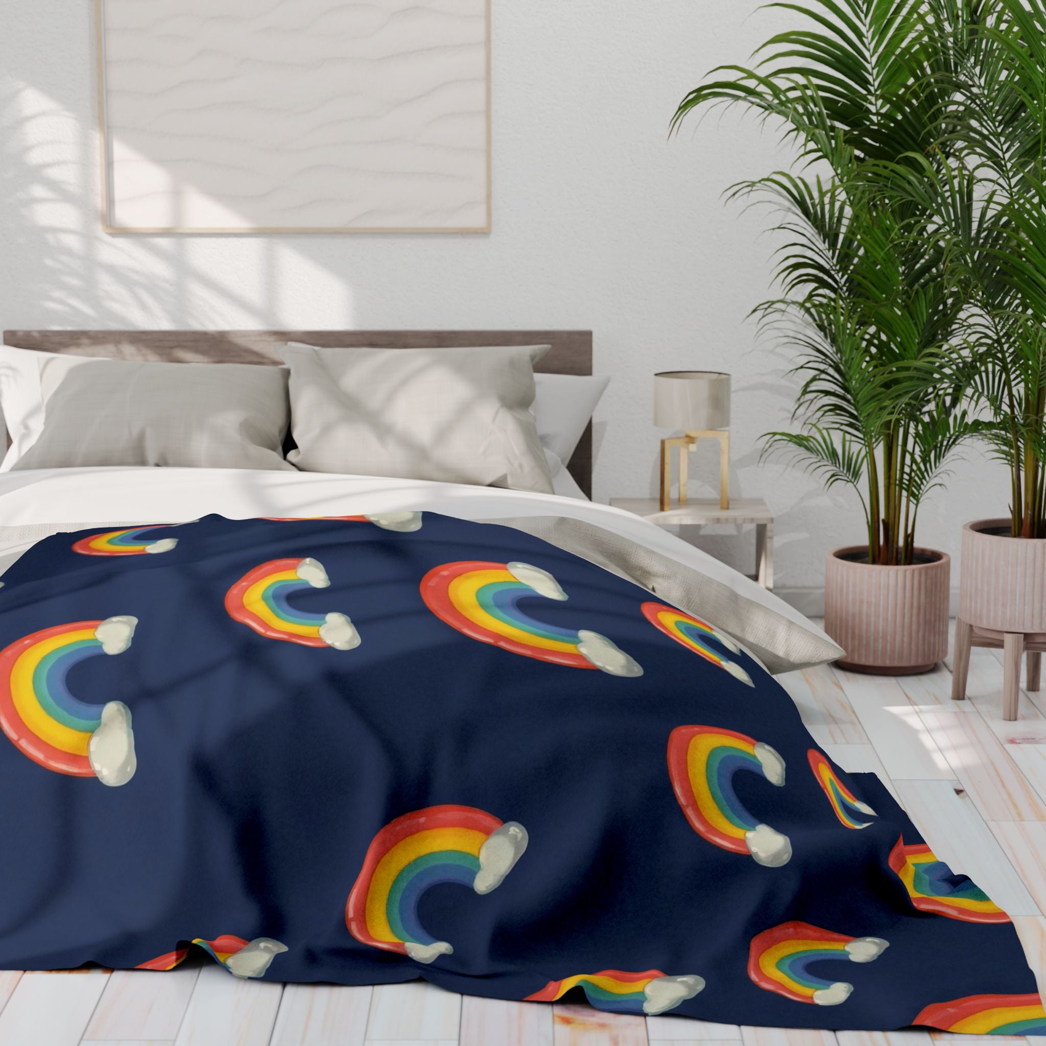 Bed with rainbow-patterned navy blanket in a bright bedroom
