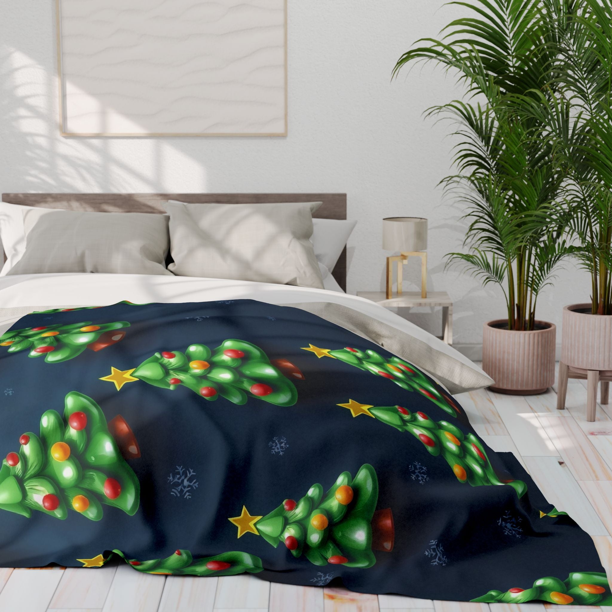Bed with Christmas tree-themed fleece blanket in a bright bedroom.