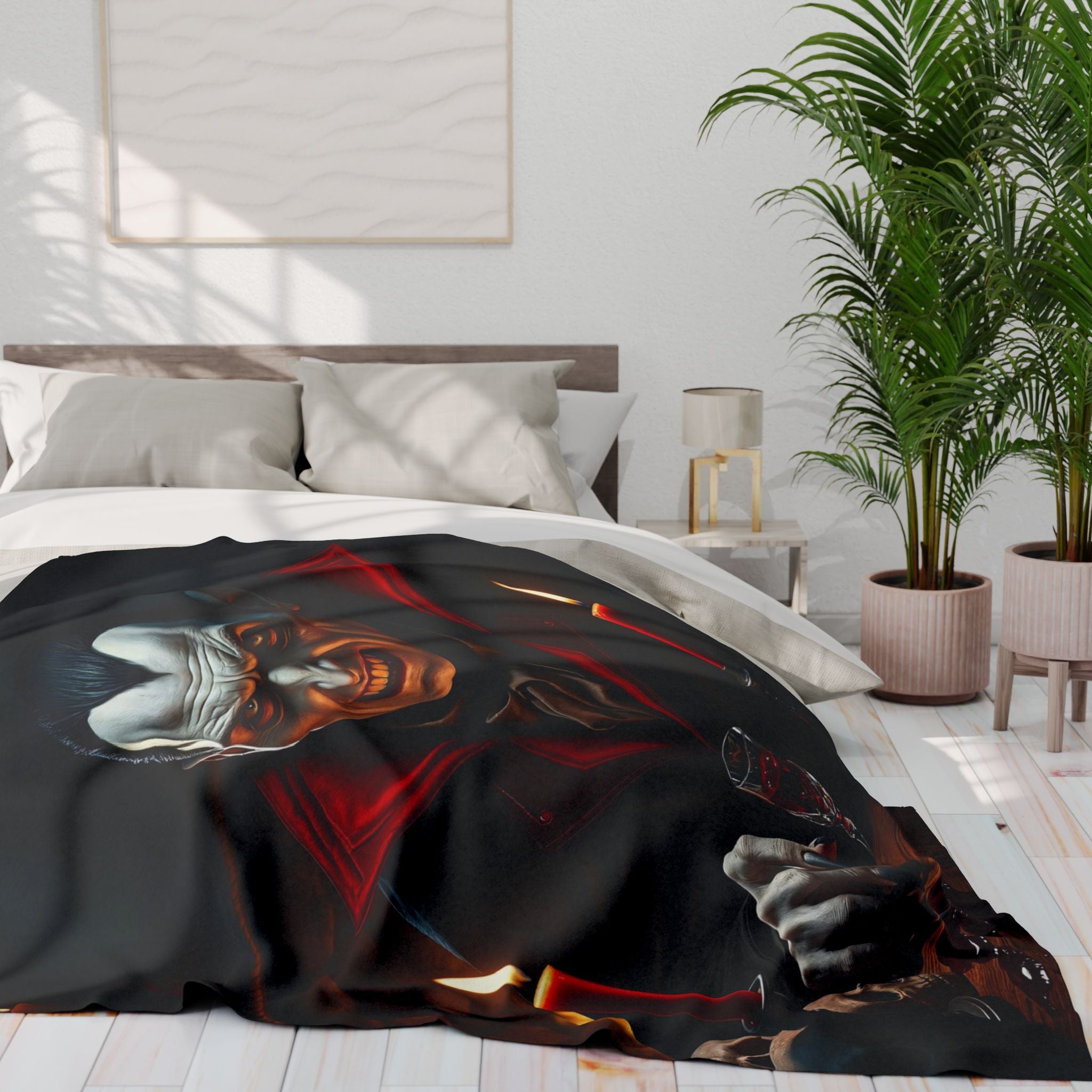 Bed with a black fleece blanket featuring count dracula, in a room with a plant and lamp.