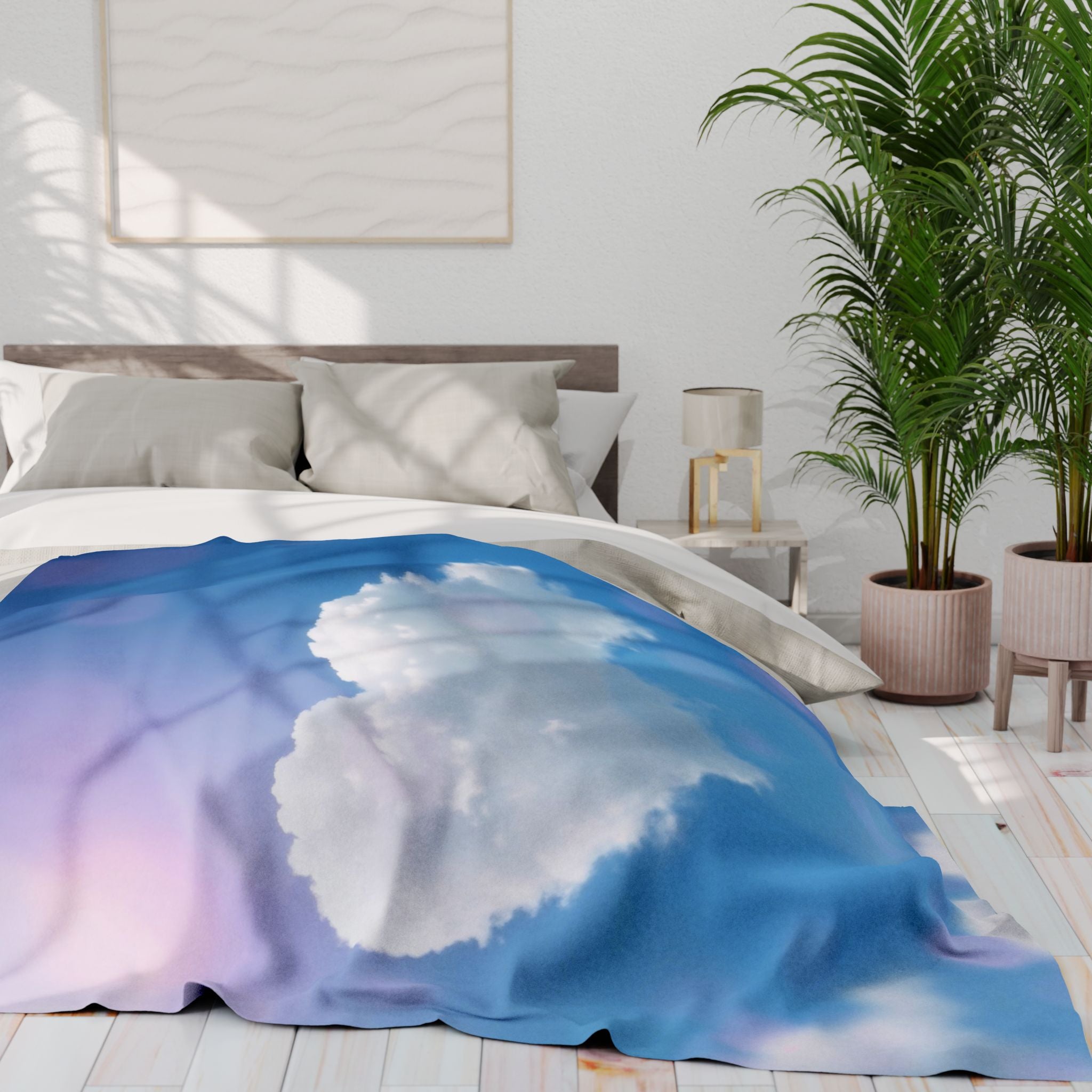 Bed with a heart cloud on a blue sky fleece blanket in a bright bedroom.