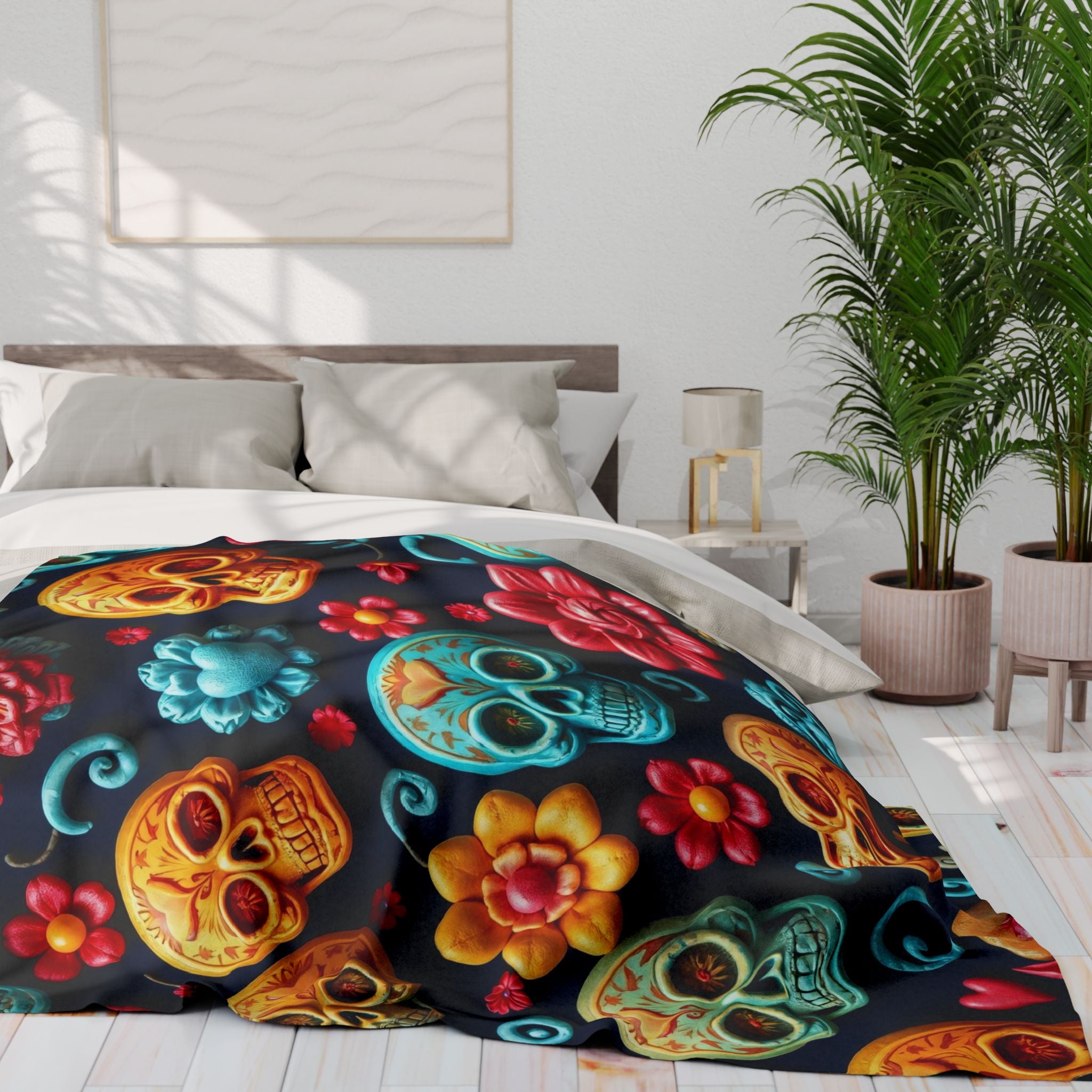 Colorful sugar skull and floral patterned blanket on a bed in a bedroom with plants and a lamp.