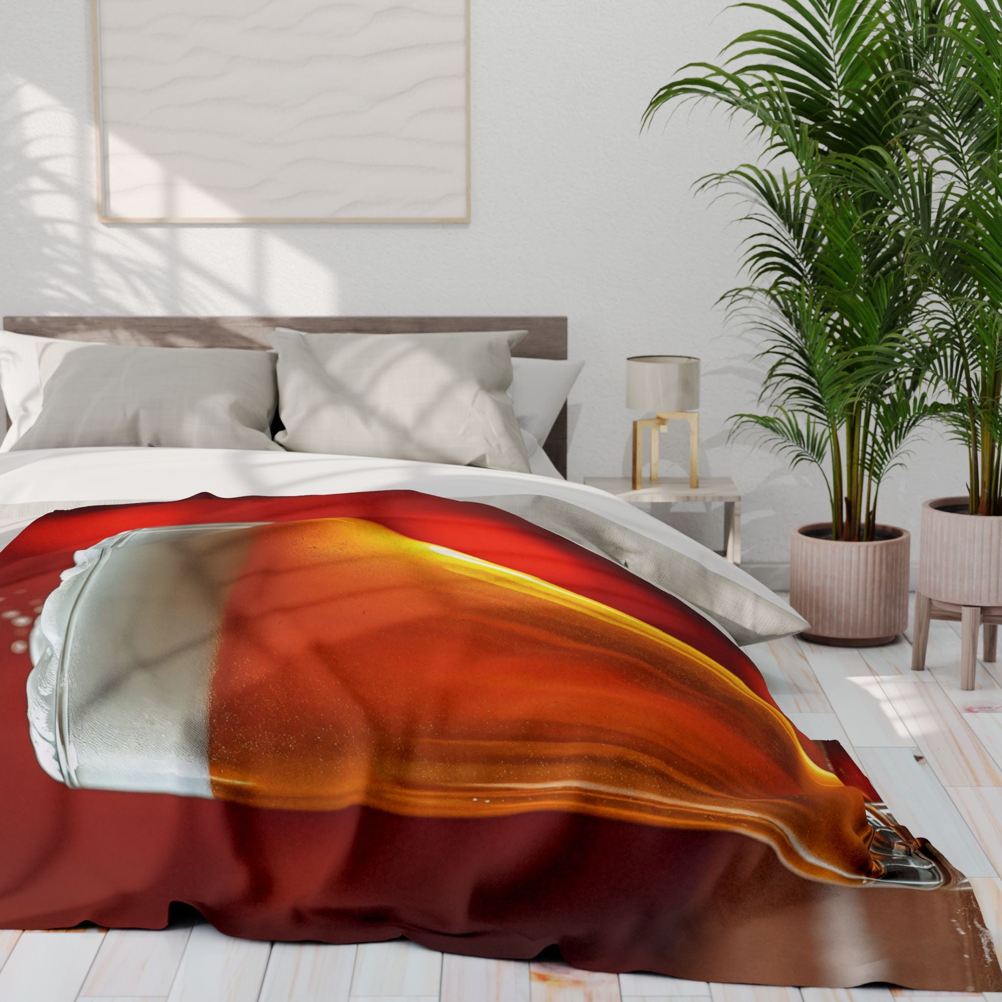 Bedroom with a blanket design of a pint of lager draped over the bed, a lamp, and plants.