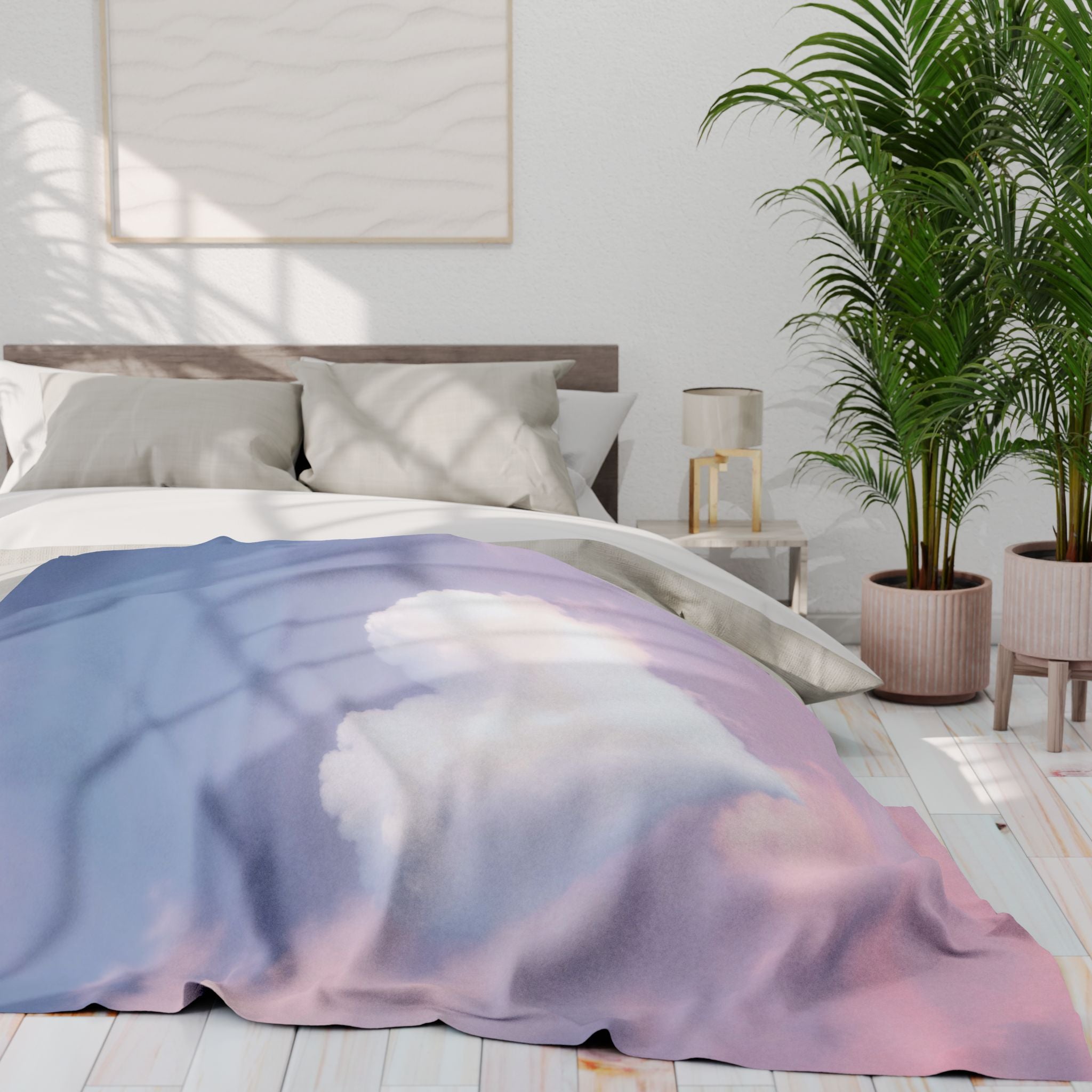 Bed with a heart shaped cloud patterned blanket in a bright bedroom with plants and a lamp.