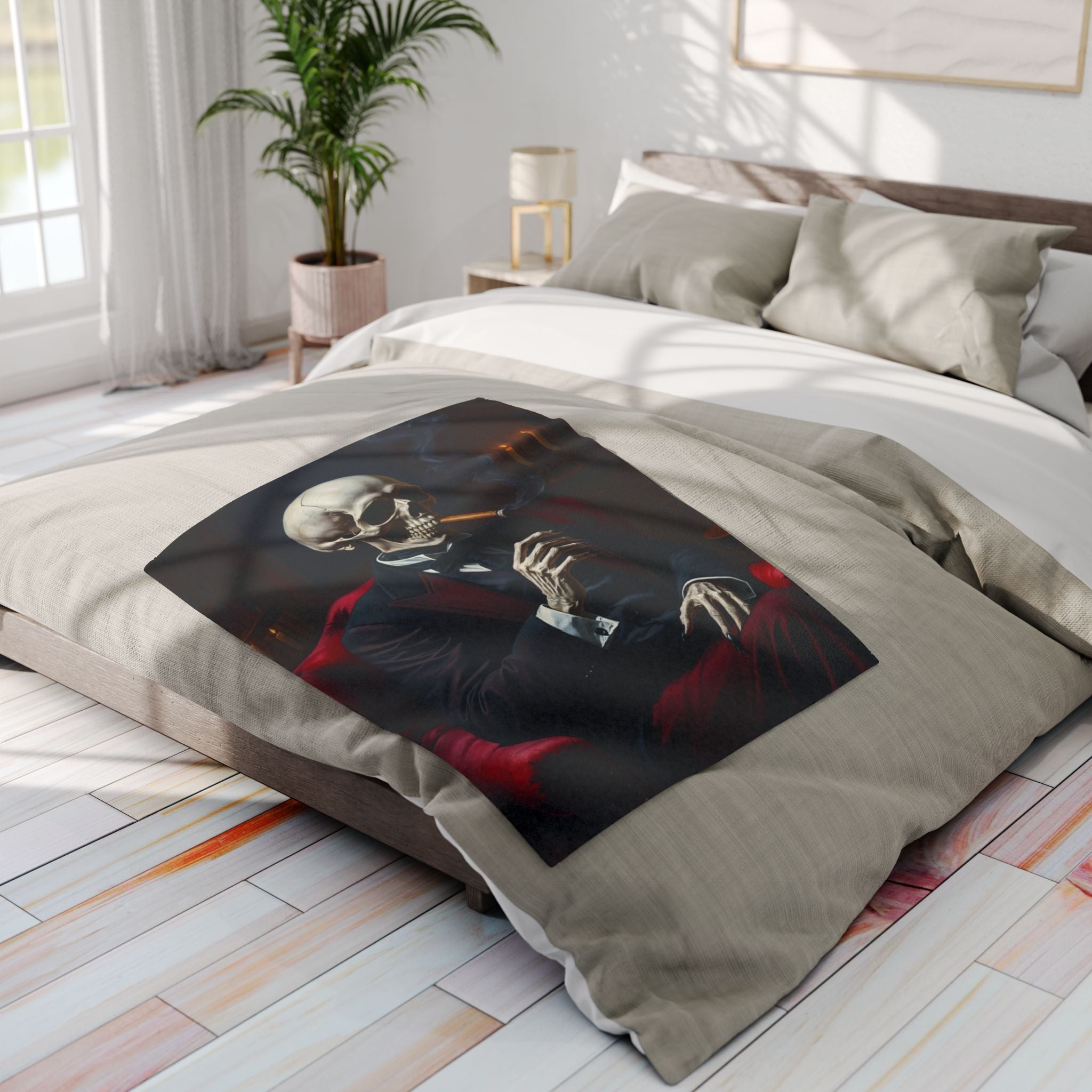 Bed with a decorative fleece blanket featuring a skeleton design in a bedroom setting.