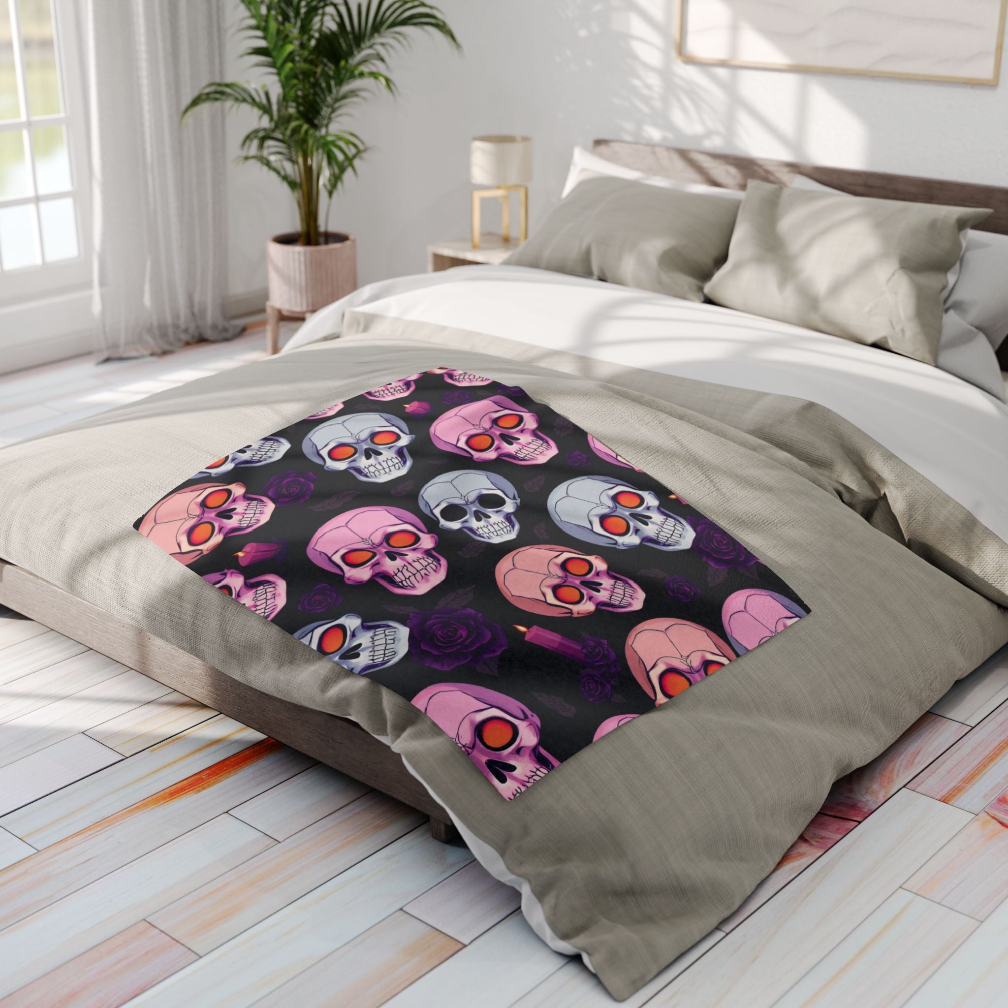 Bed with a colorful Halloween skull patterned blanket in a bright bedroom.