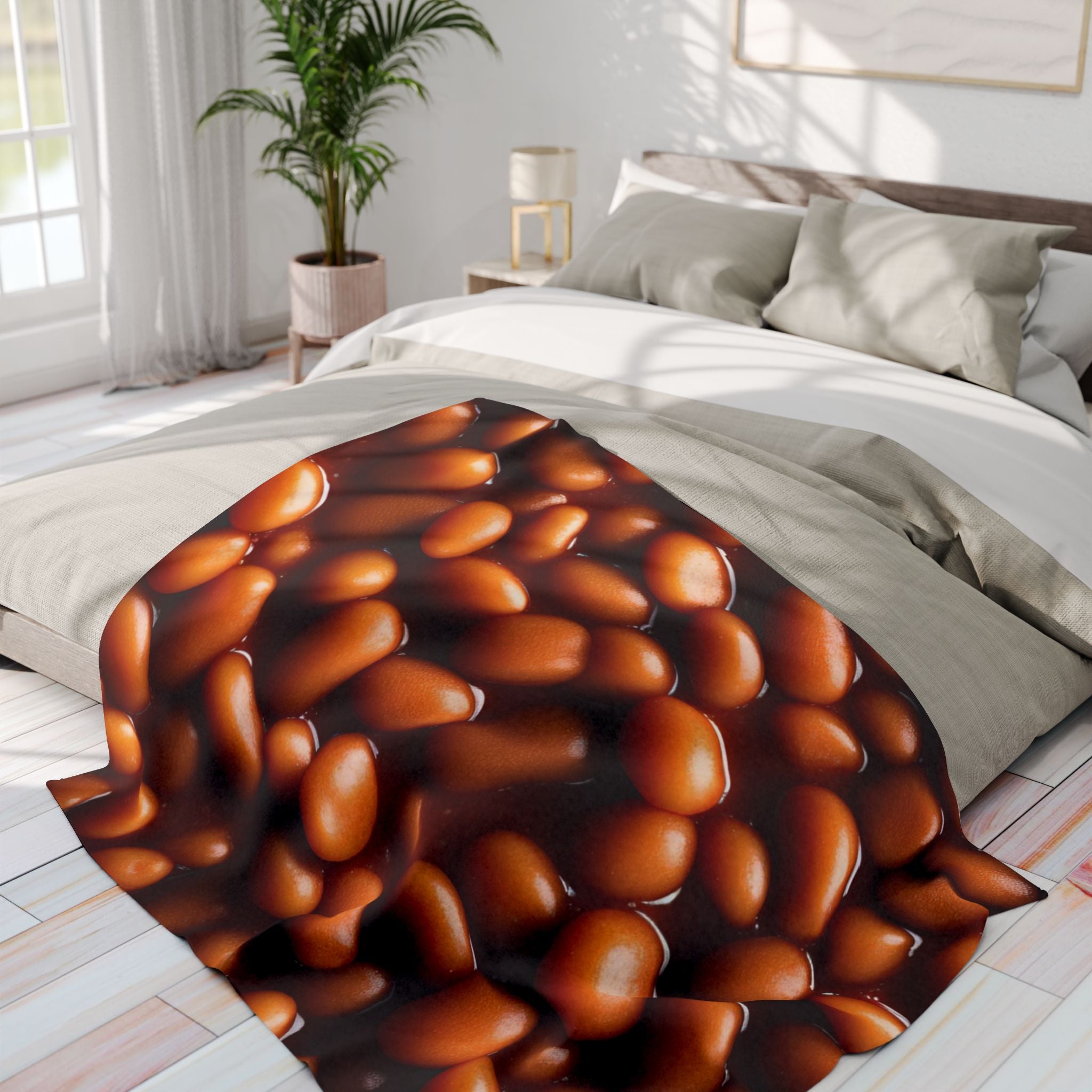 Warm fleece blanket with a baked bean design in a bedroom setting.