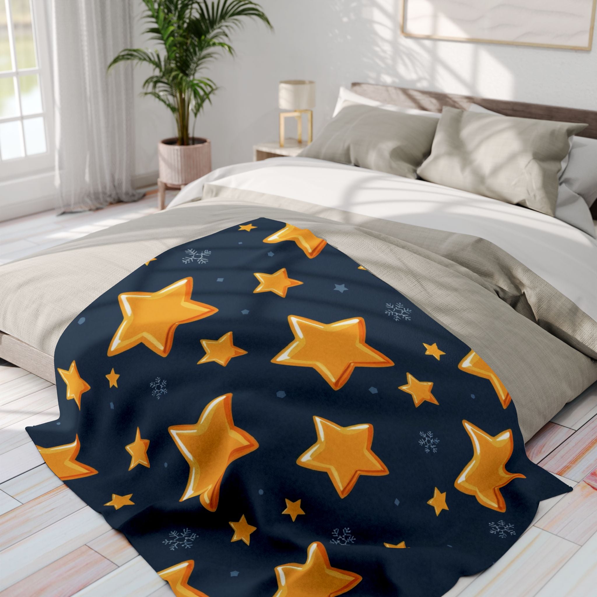 Gold star patterned blanket on a bed in a bright bedroom.