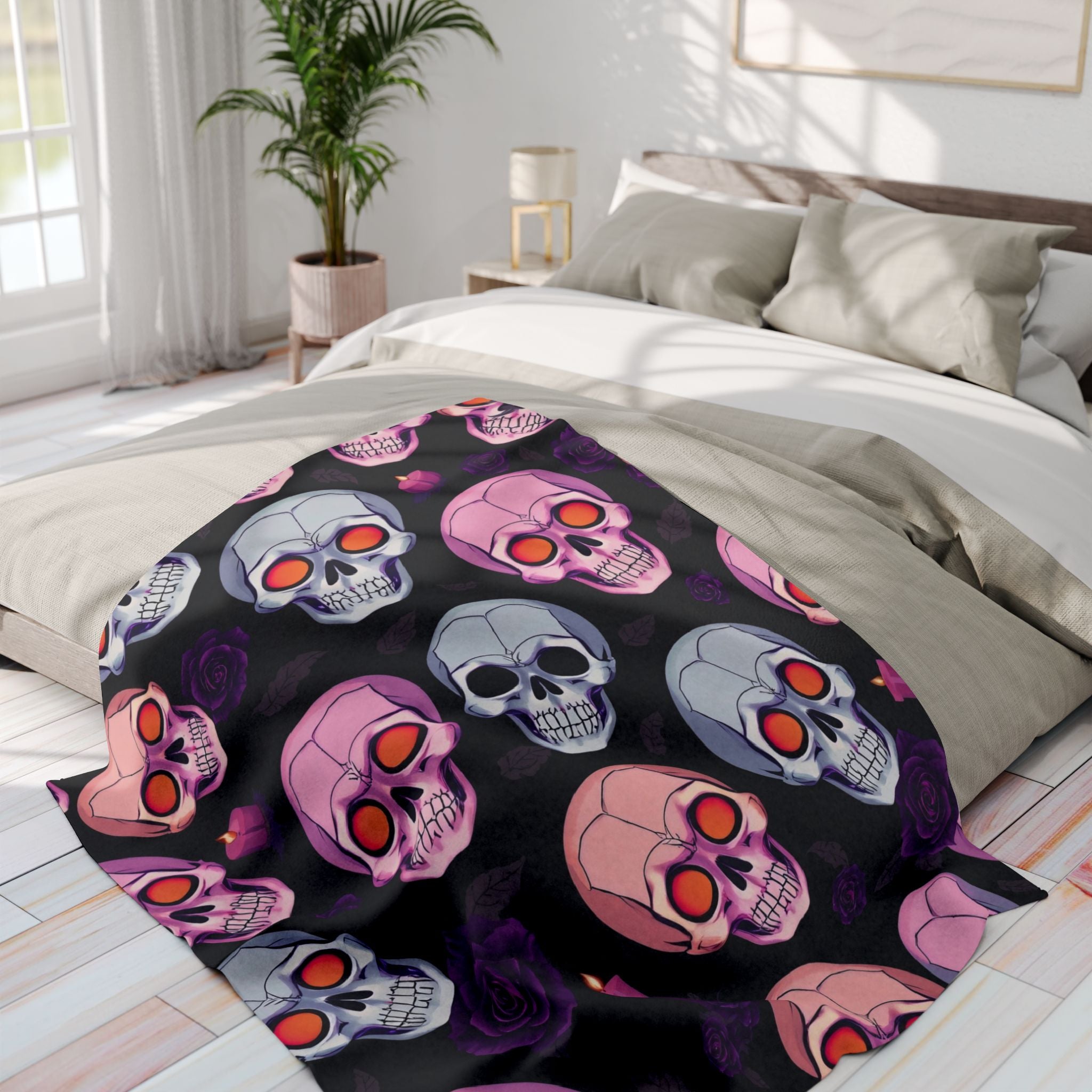 Halloween gothic skull and purple rose patterned fleece blanket on a bed in a bright bedroom.