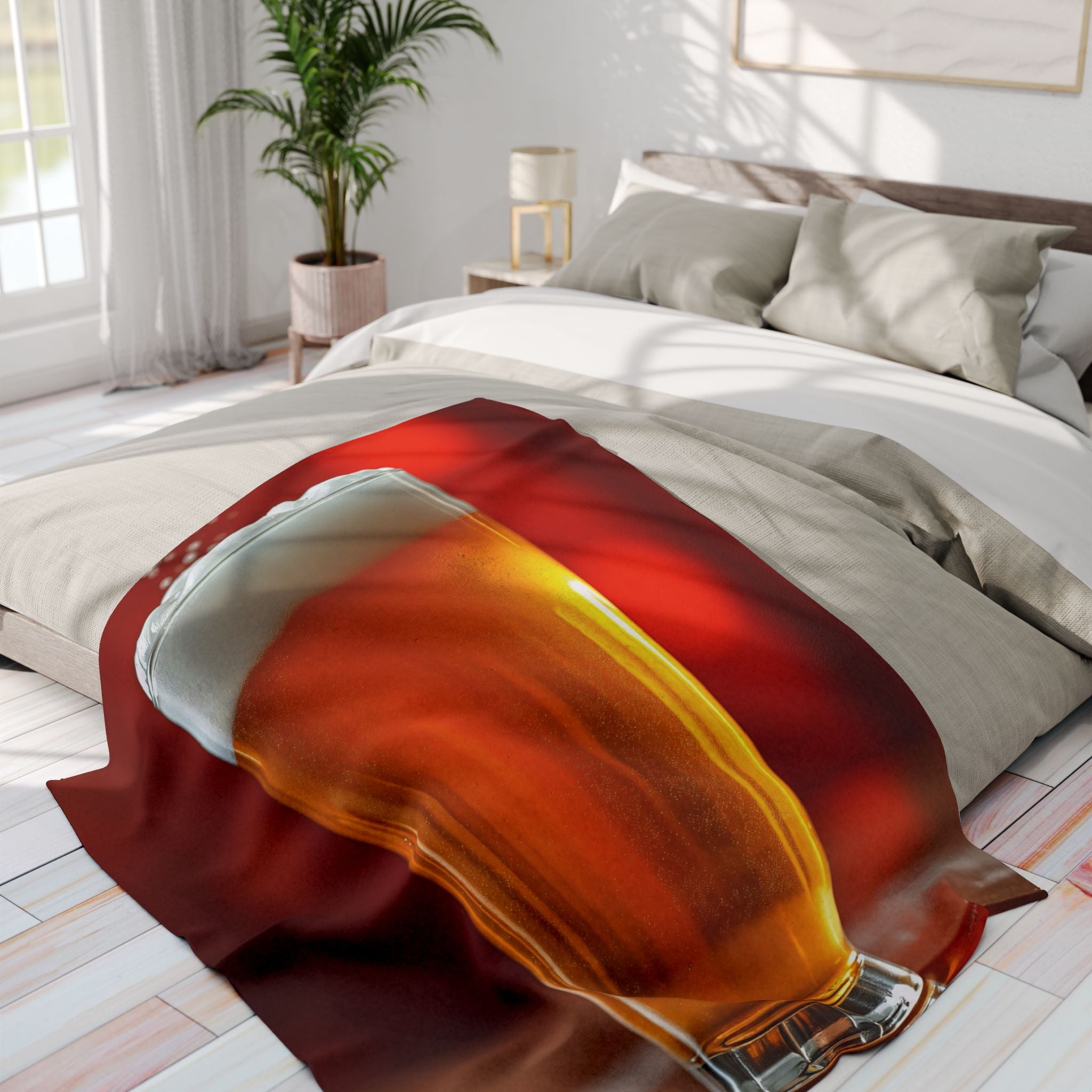 Printed fleece blanket of a pint of lager on a bed in a bright bedroom.
